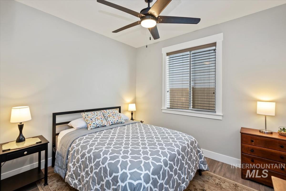 Bedroom with wood finished floors and a ceiling fan
