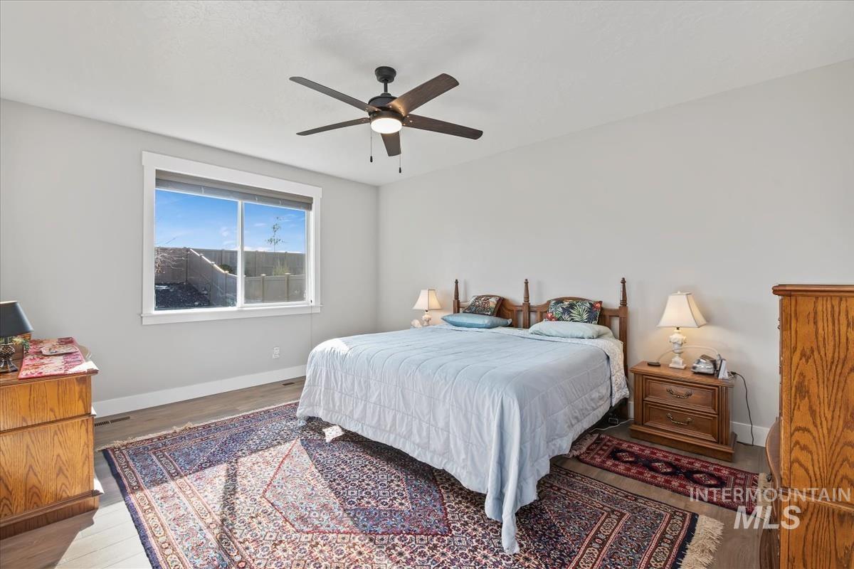Bedroom featuring wood finished floors and ceiling fan