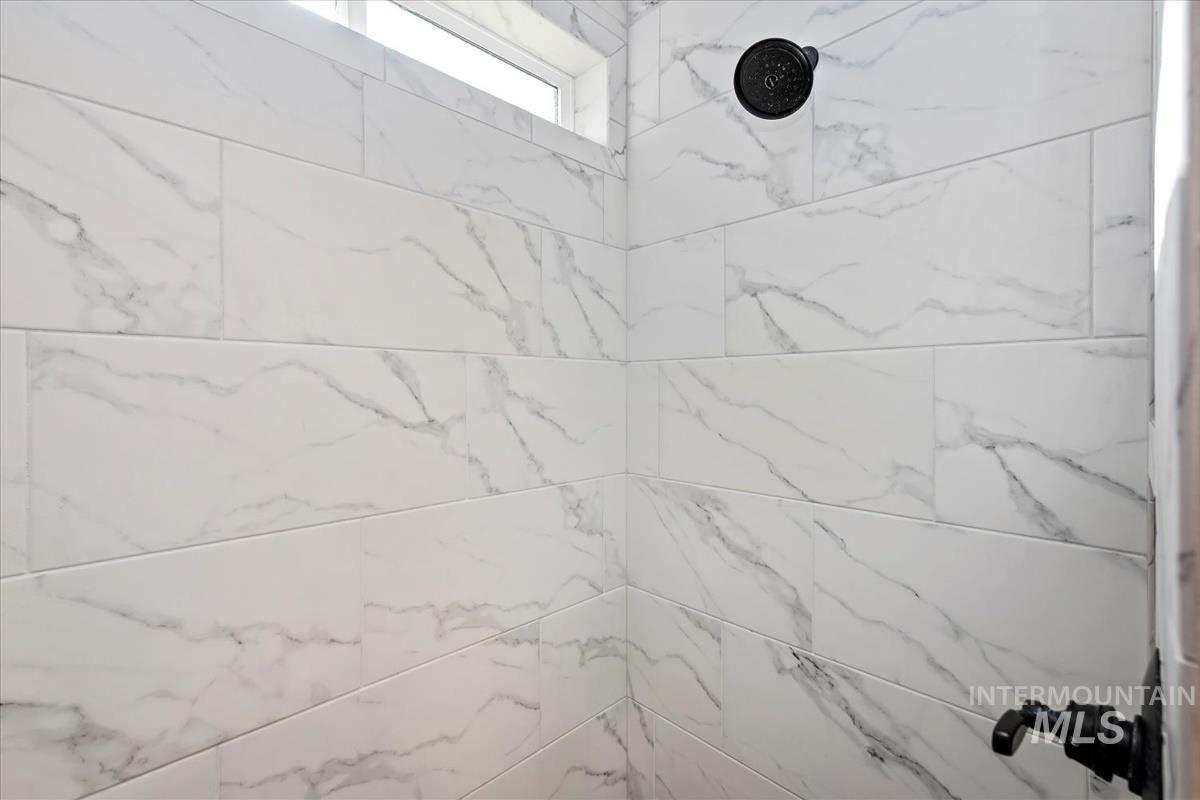 Bathroom view of a marble finish shower