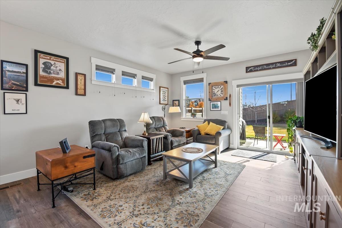 Living room featuring wood finished floors and a ceiling fan