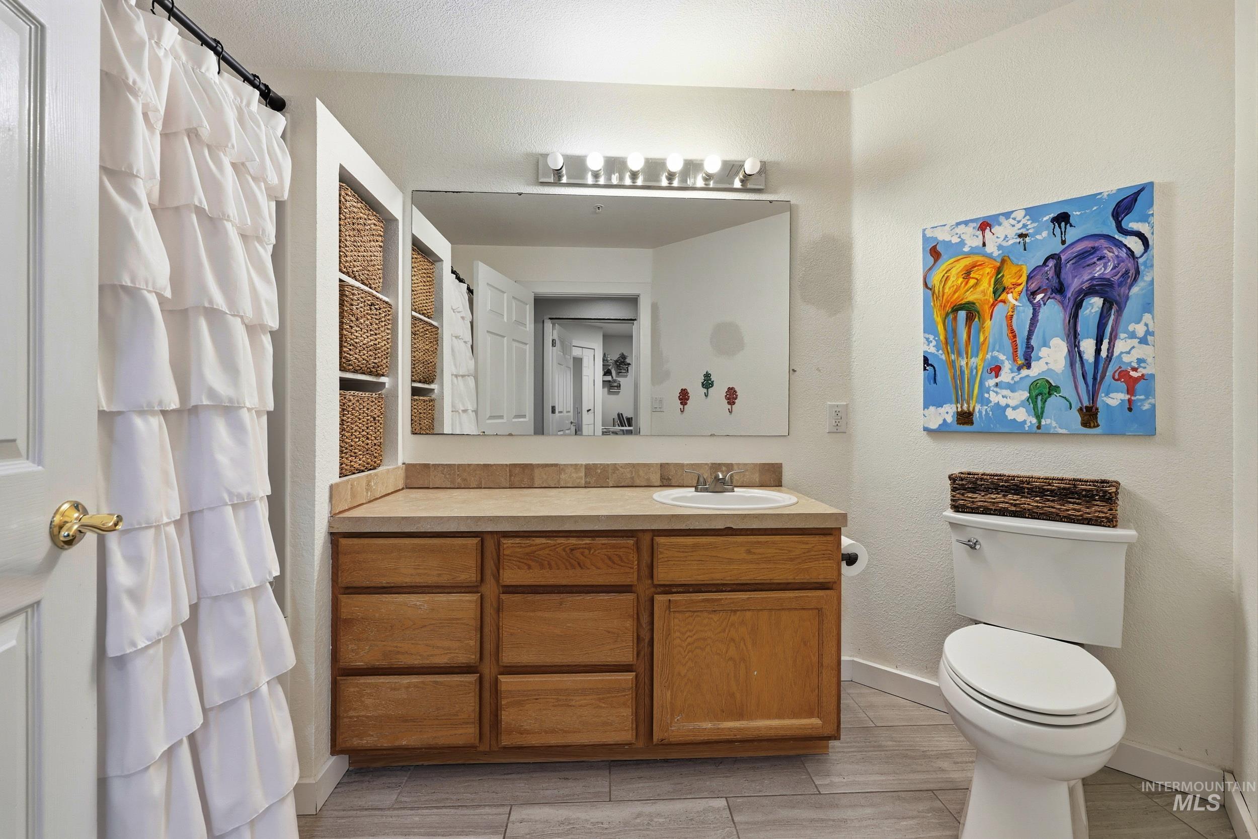 Bathroom with vanity and curtained shower