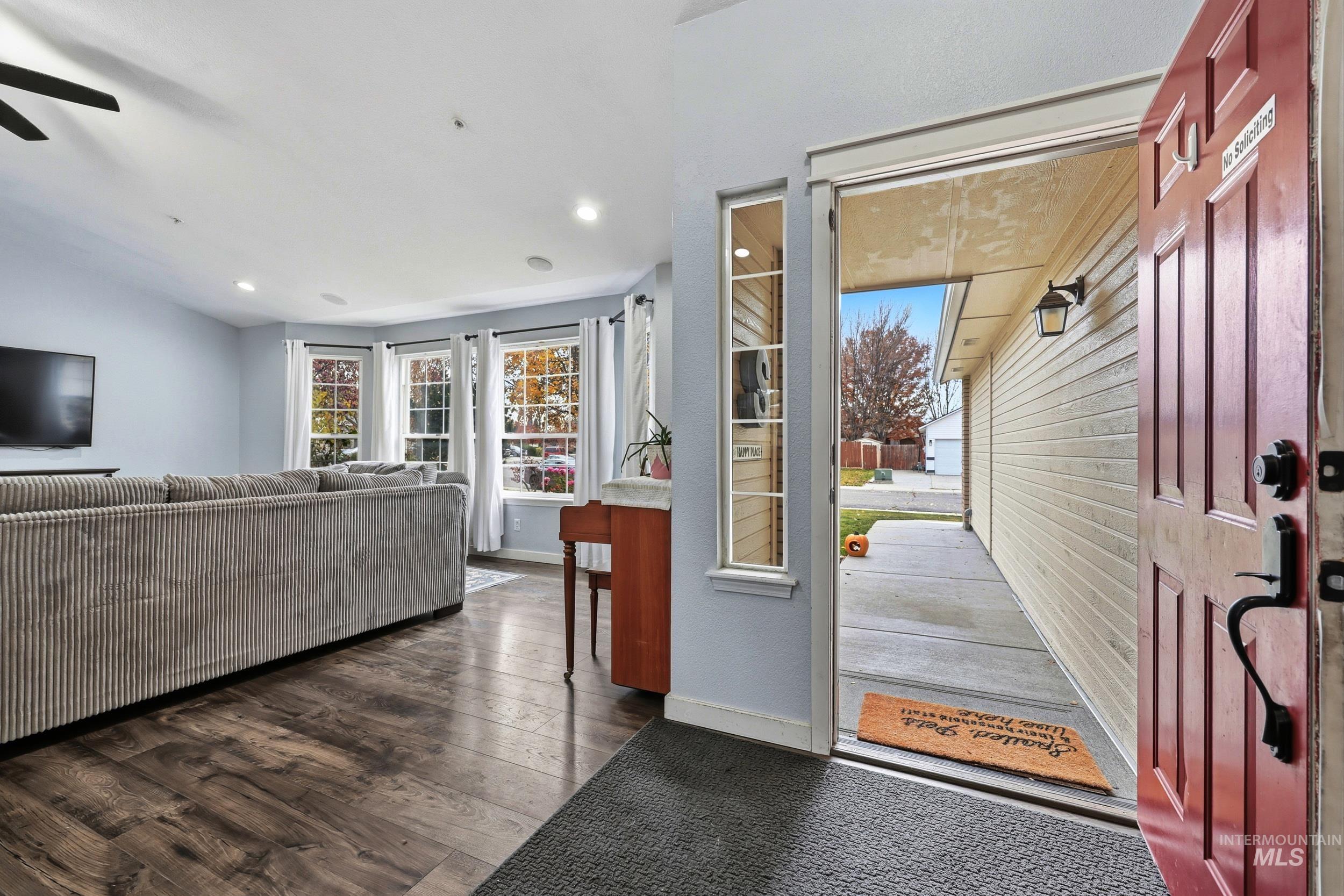 Foyer entrance featuring dark wood-style floors, plenty of natural light, and recessed lighting