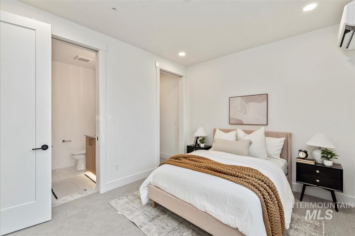 Bedroom with carpet floors, recessed lighting, and a wall unit AC