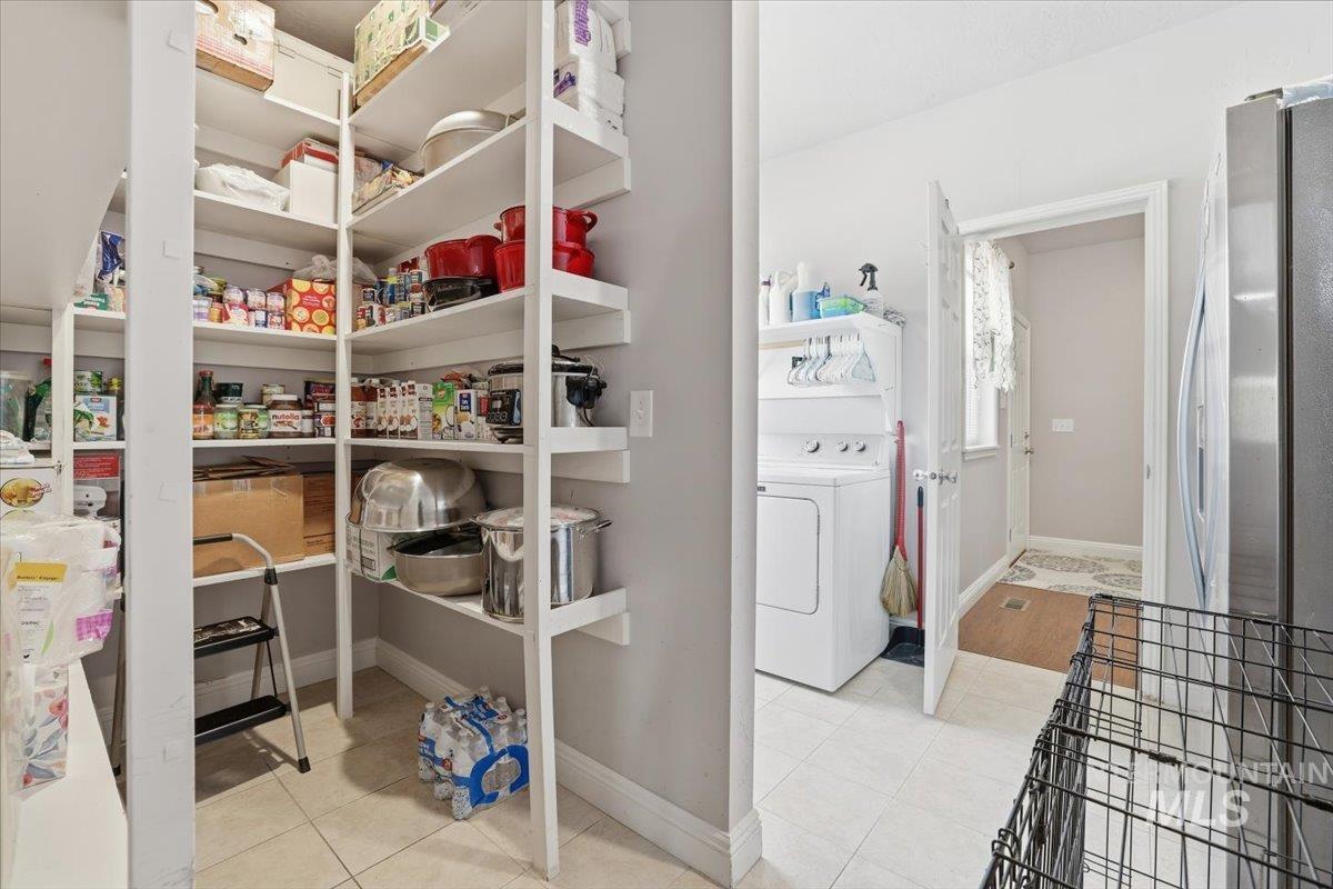 Pantry featuring washer / clothes dryer