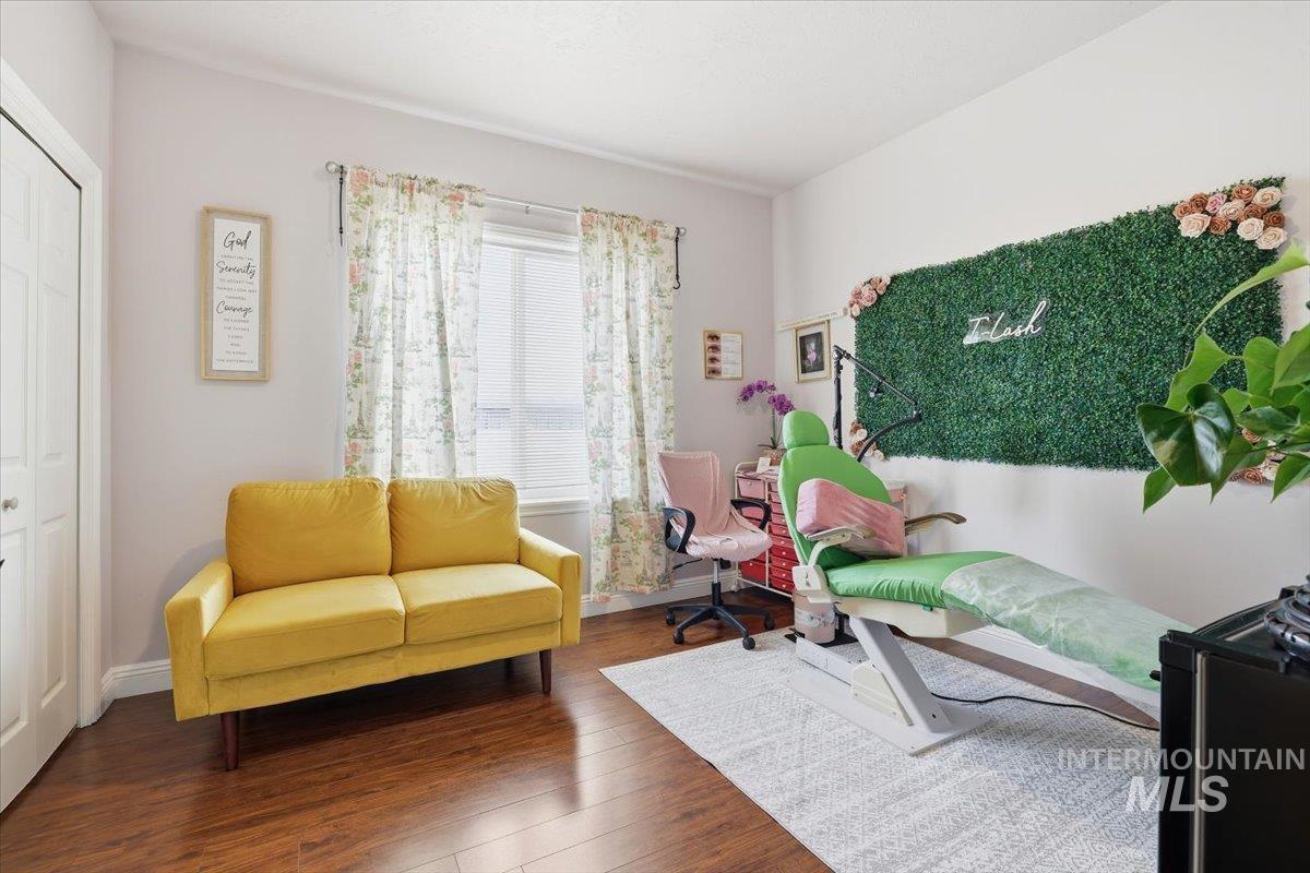 Living area with wood finished floors and baseboards