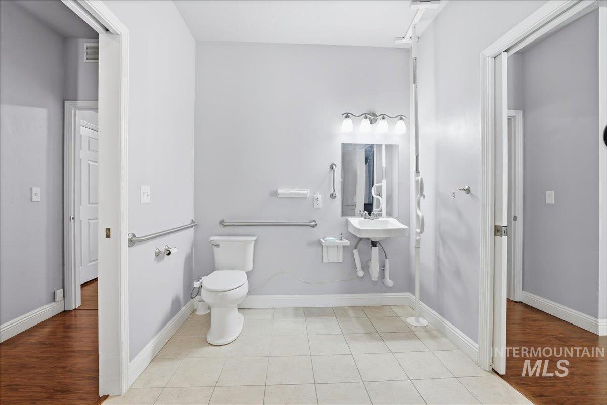 Half bathroom with light tile patterned floors and baseboards