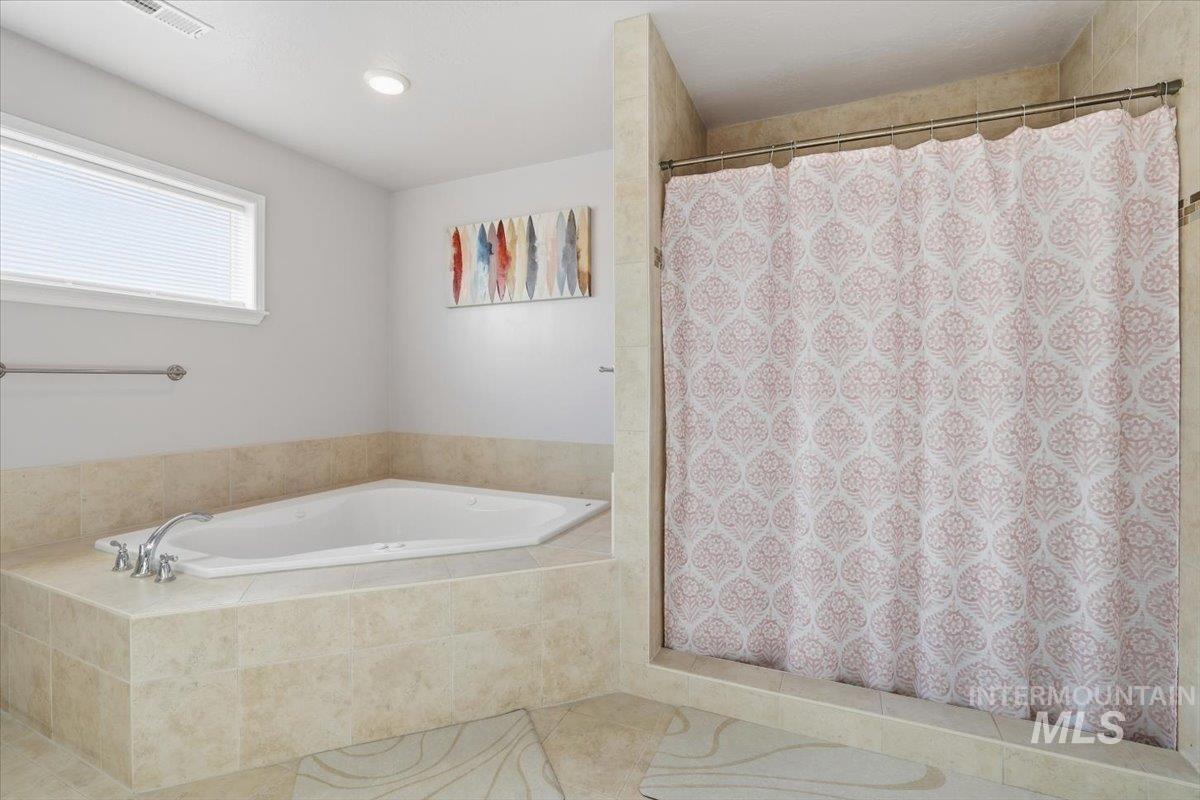 Bathroom featuring a shower with shower curtain, a bath, tile patterned floors, and recessed lighting