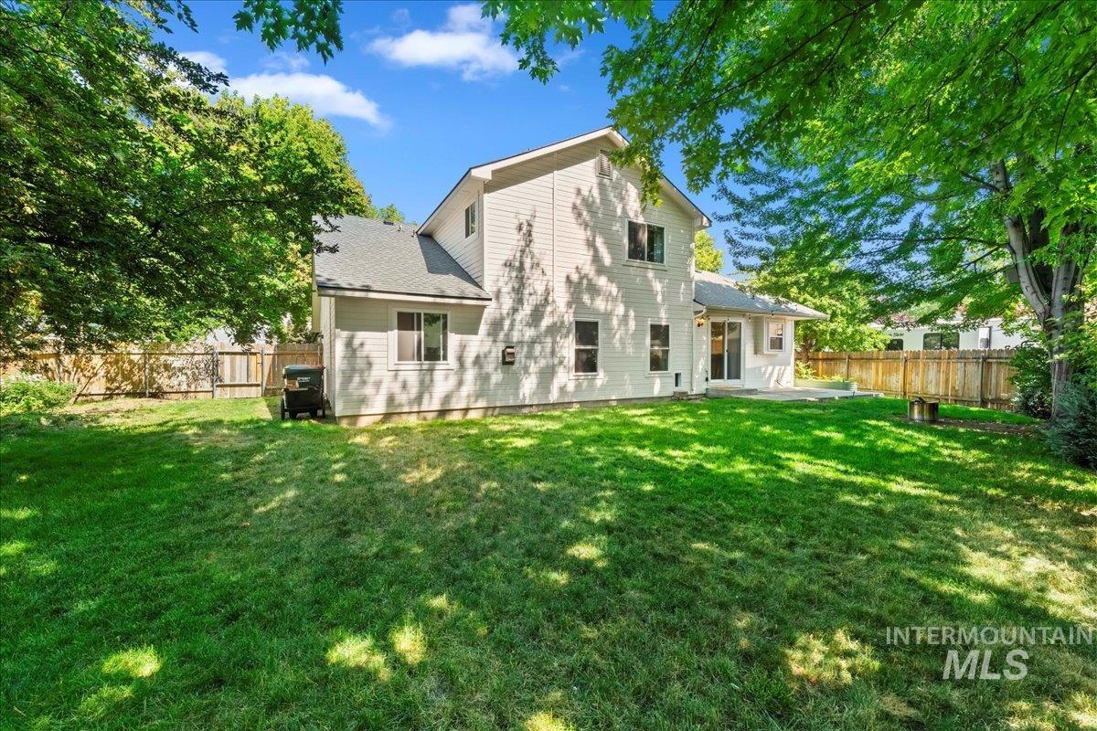 Rear view of property featuring a patio area and a fenced backyard