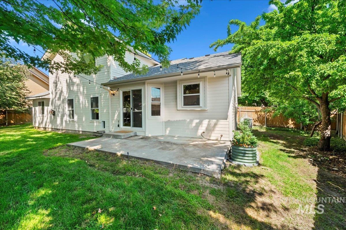 Rear view of house featuring a patio and a fenced backyard