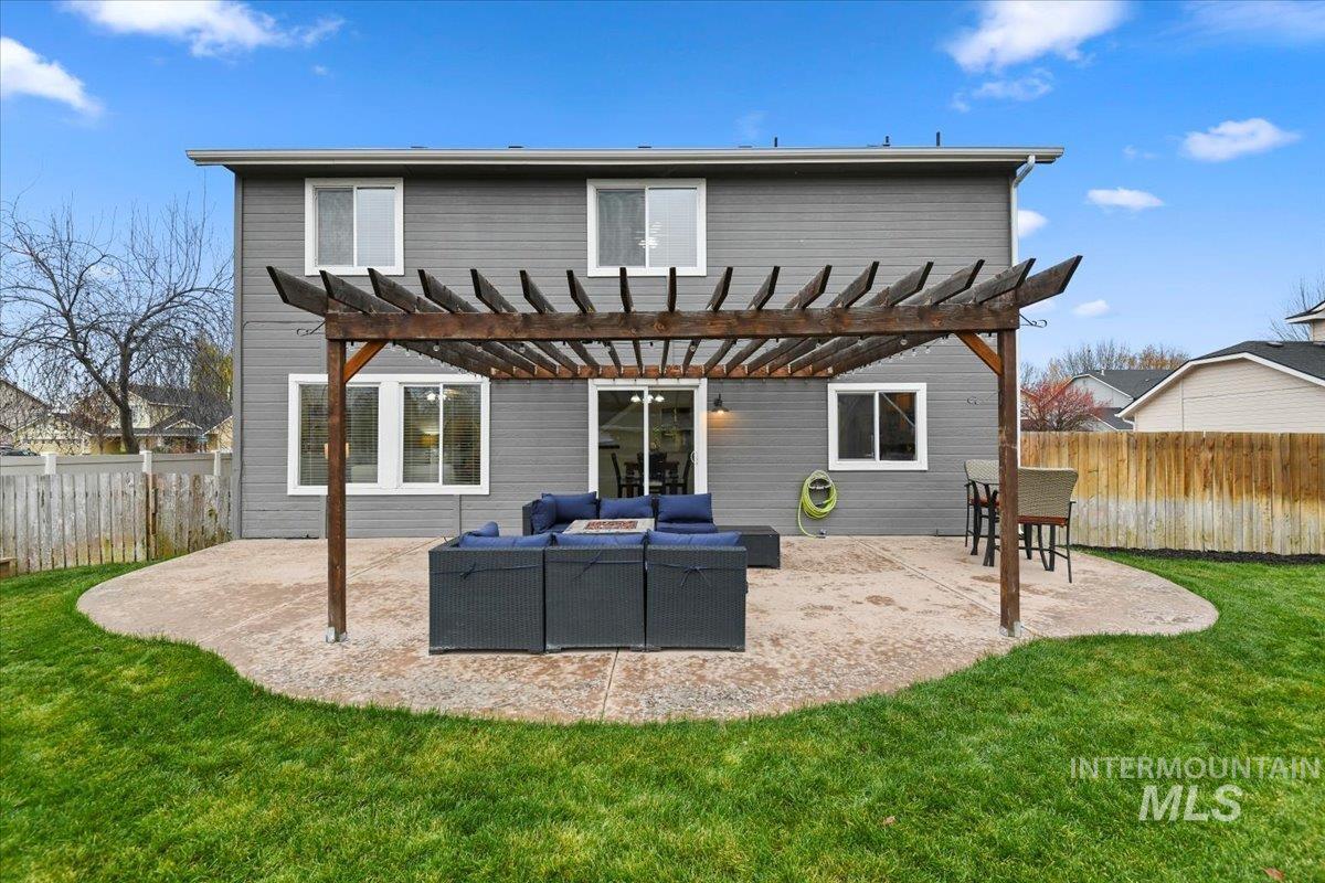 Back of house featuring a patio, a fenced backyard, an outdoor hangout area, and a pergola