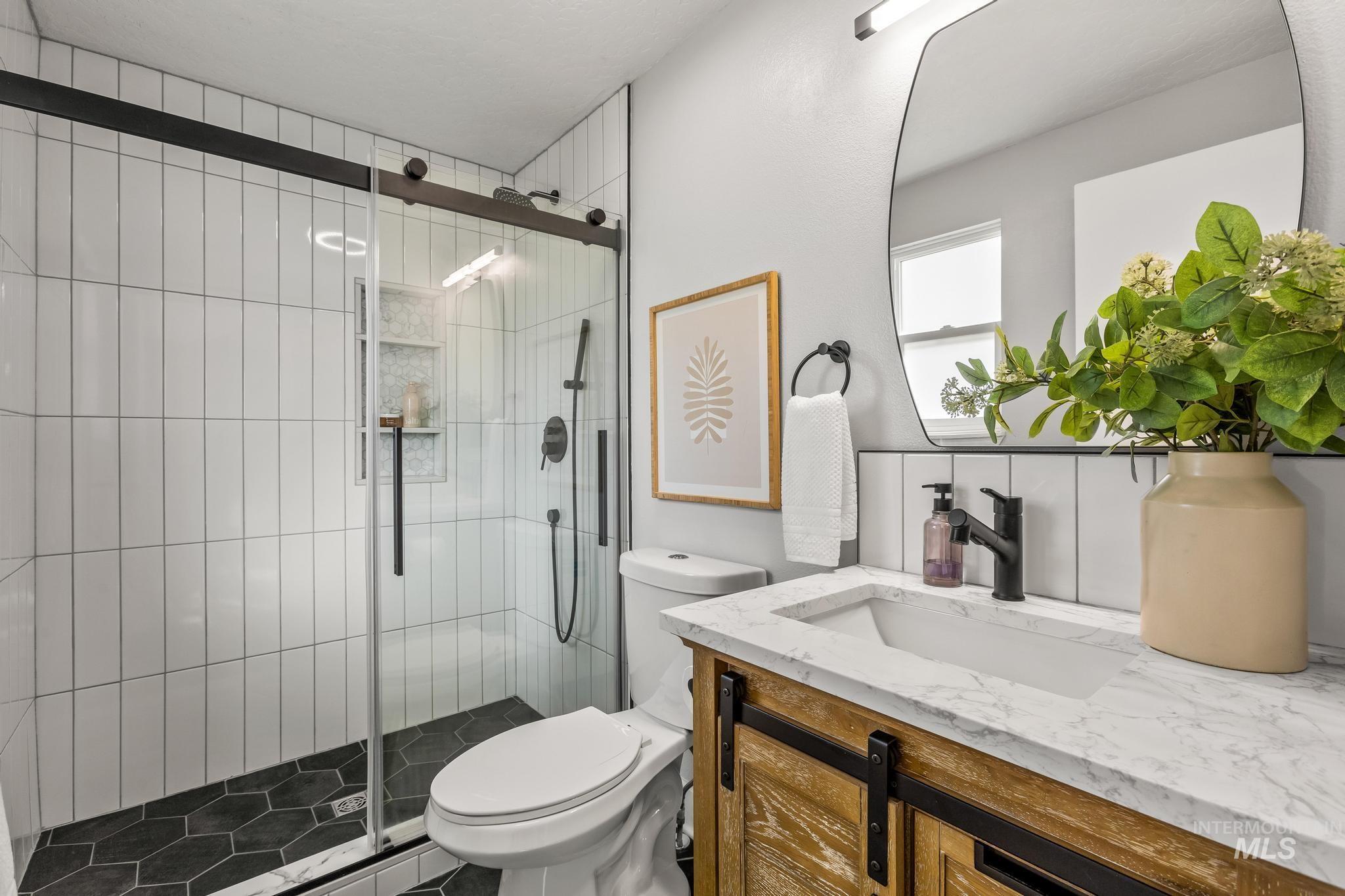 Full bathroom featuring vanity and a stall shower