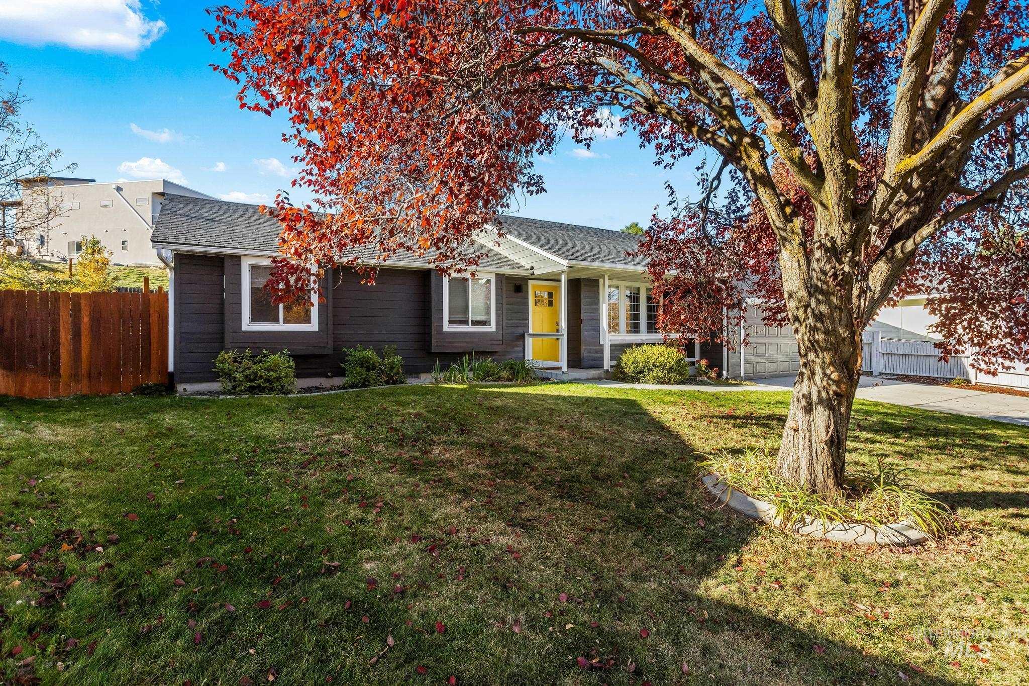 View of front of house featuring a shingled roof and concrete driveway