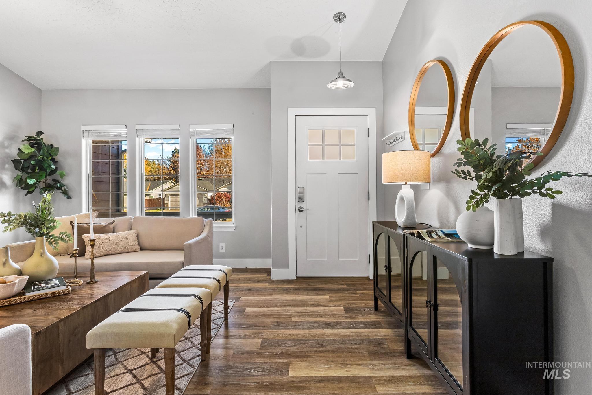 Entrance foyer with wood finished floors and baseboards