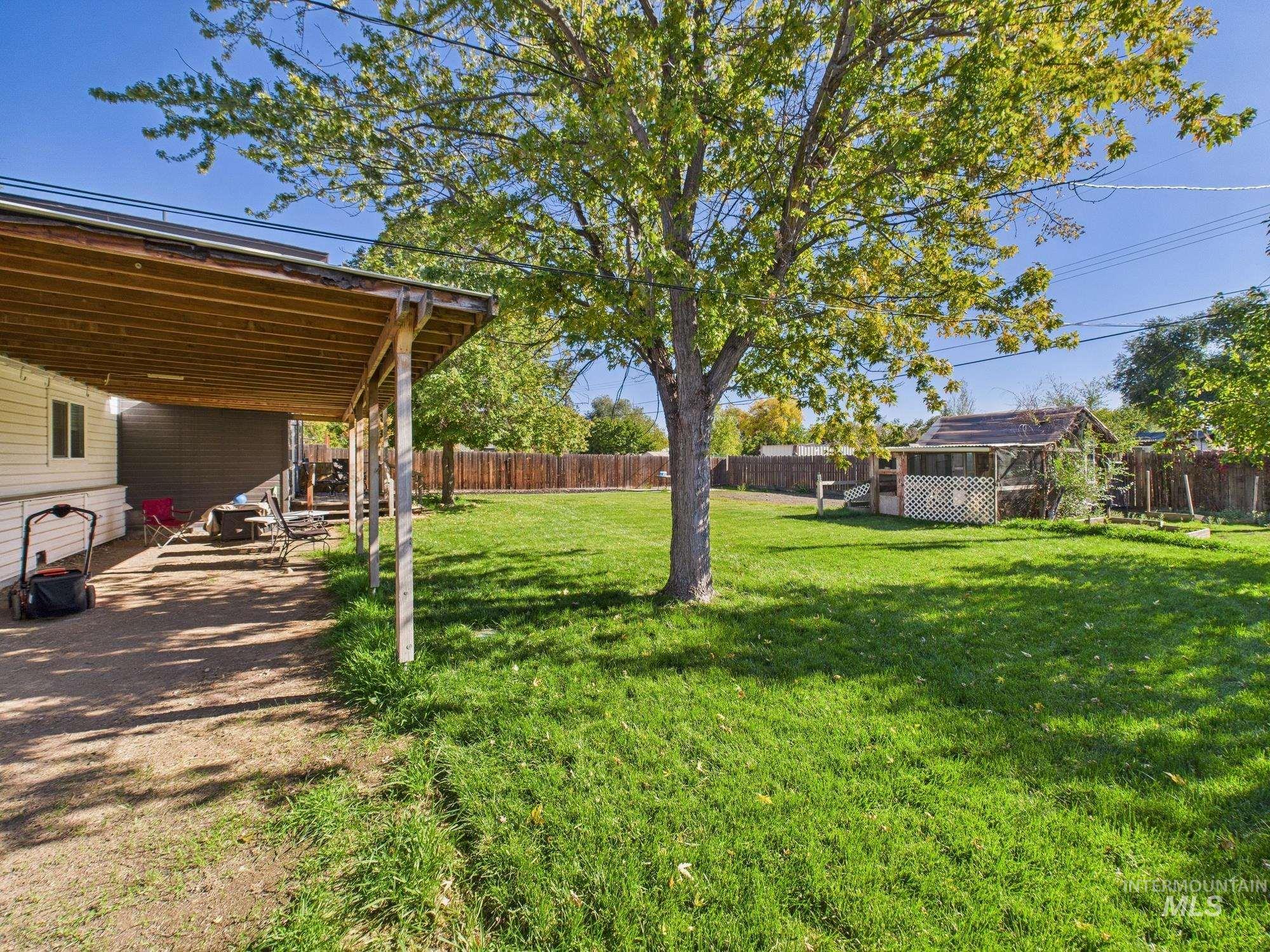 Fenced backyard with an outdoor structure