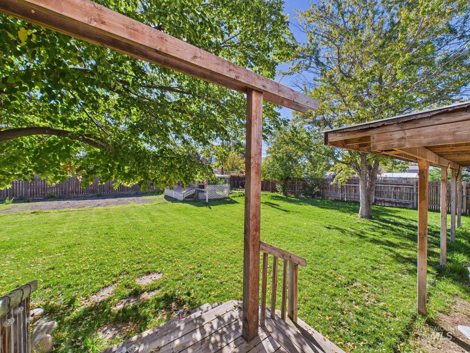 Fenced backyard with a deck
