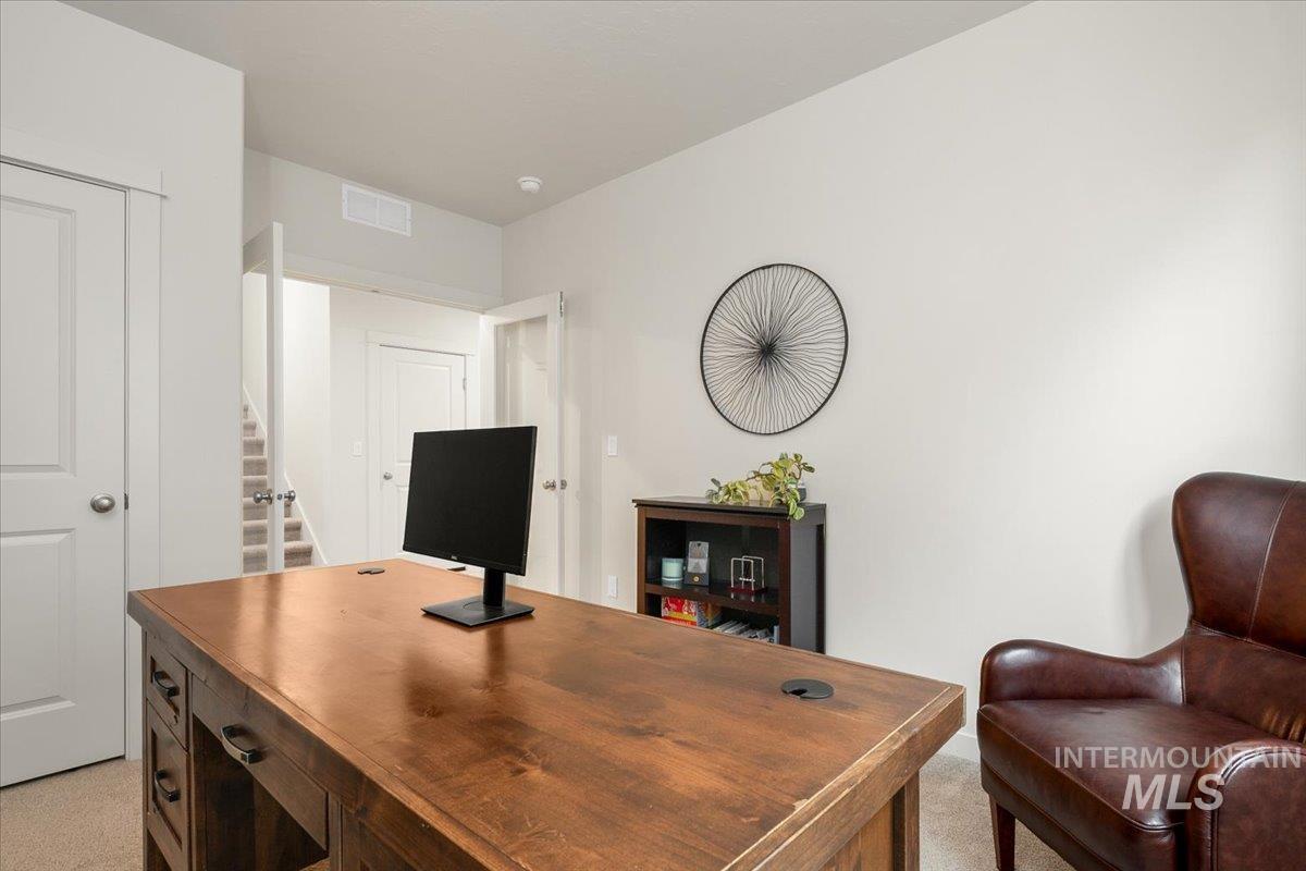 Office area featuring light colored carpet