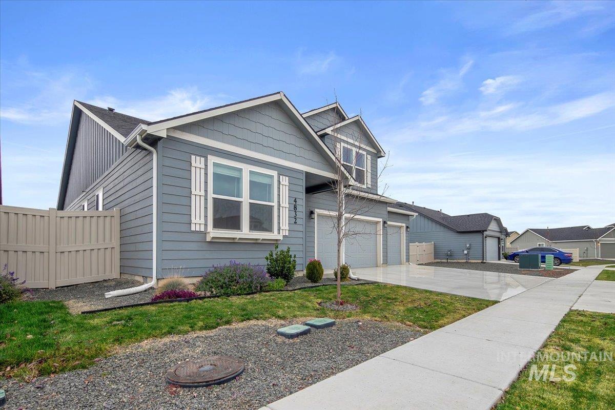 View of front facade with concrete driveway and an attached garage