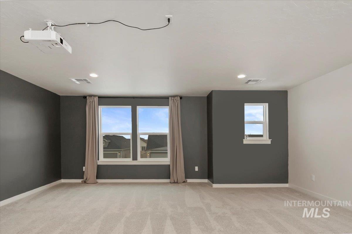 Unfurnished room featuring light carpet and recessed lighting