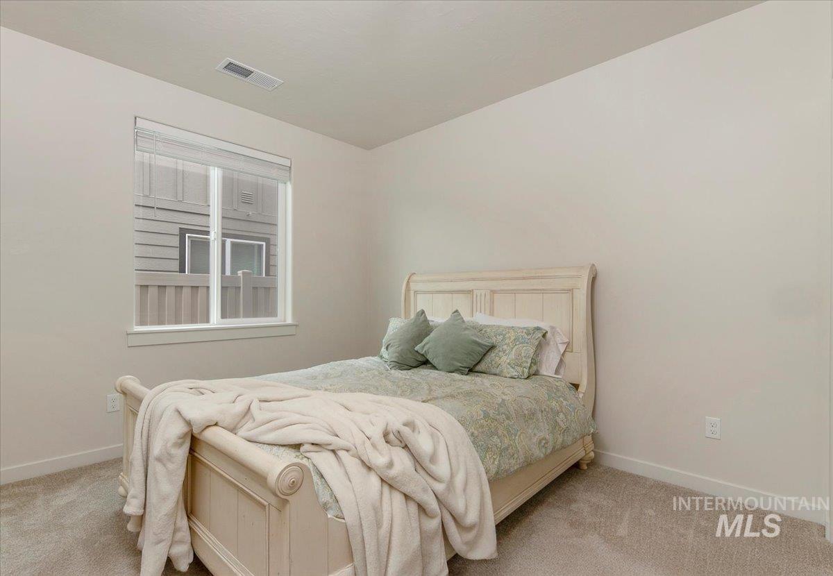 Carpeted bedroom featuring baseboards