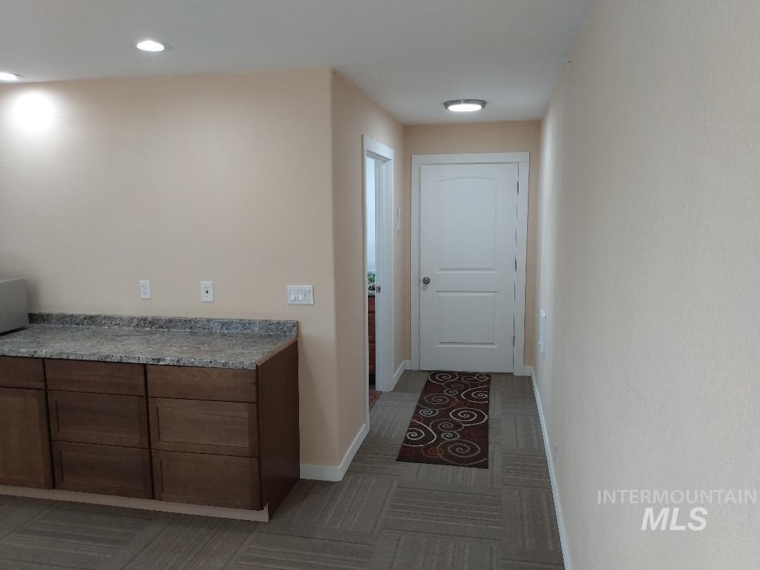 Hall with light carpet and recessed lighting