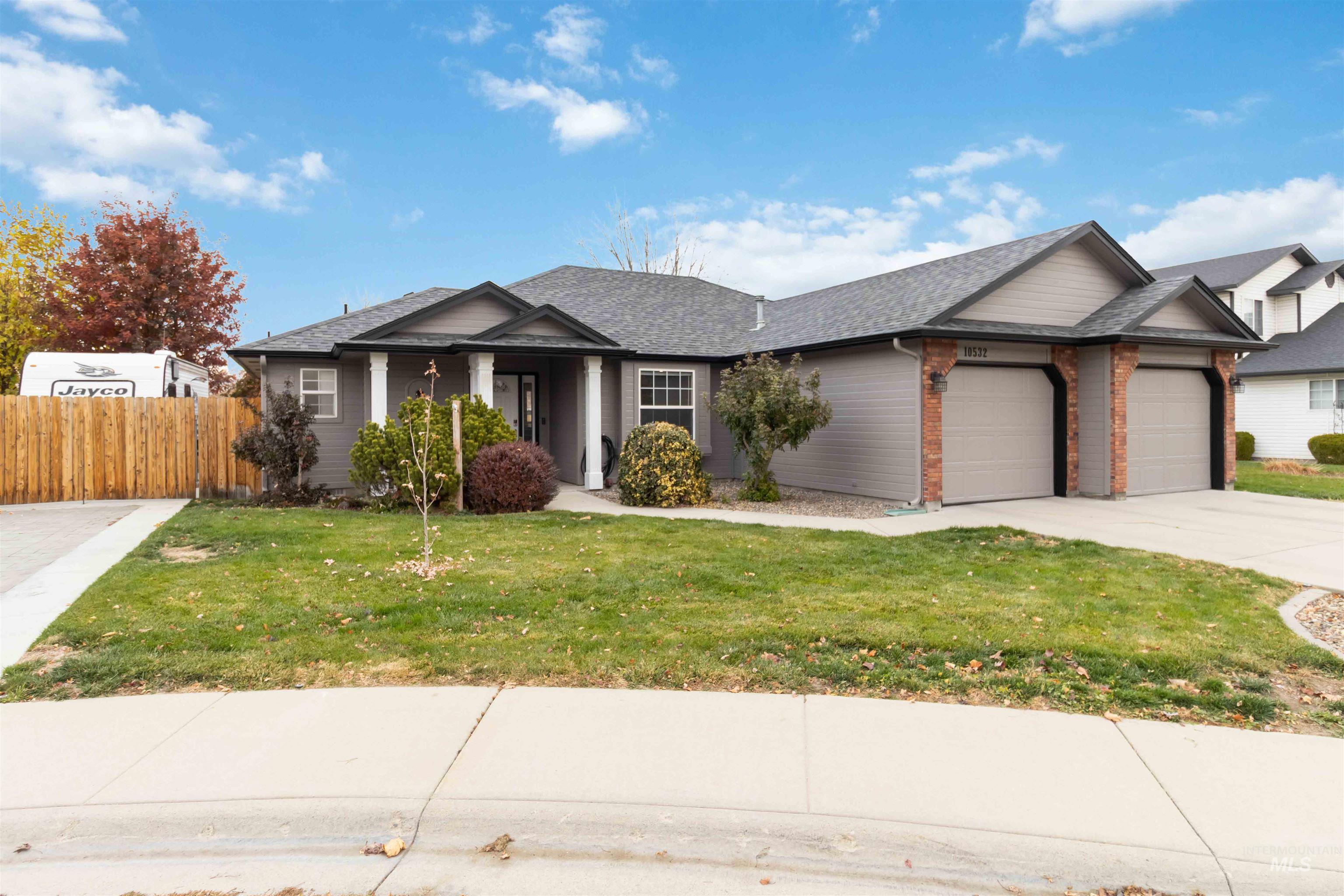 View of front of property featuring RV parking, brick siding, a garage, and concrete driveway