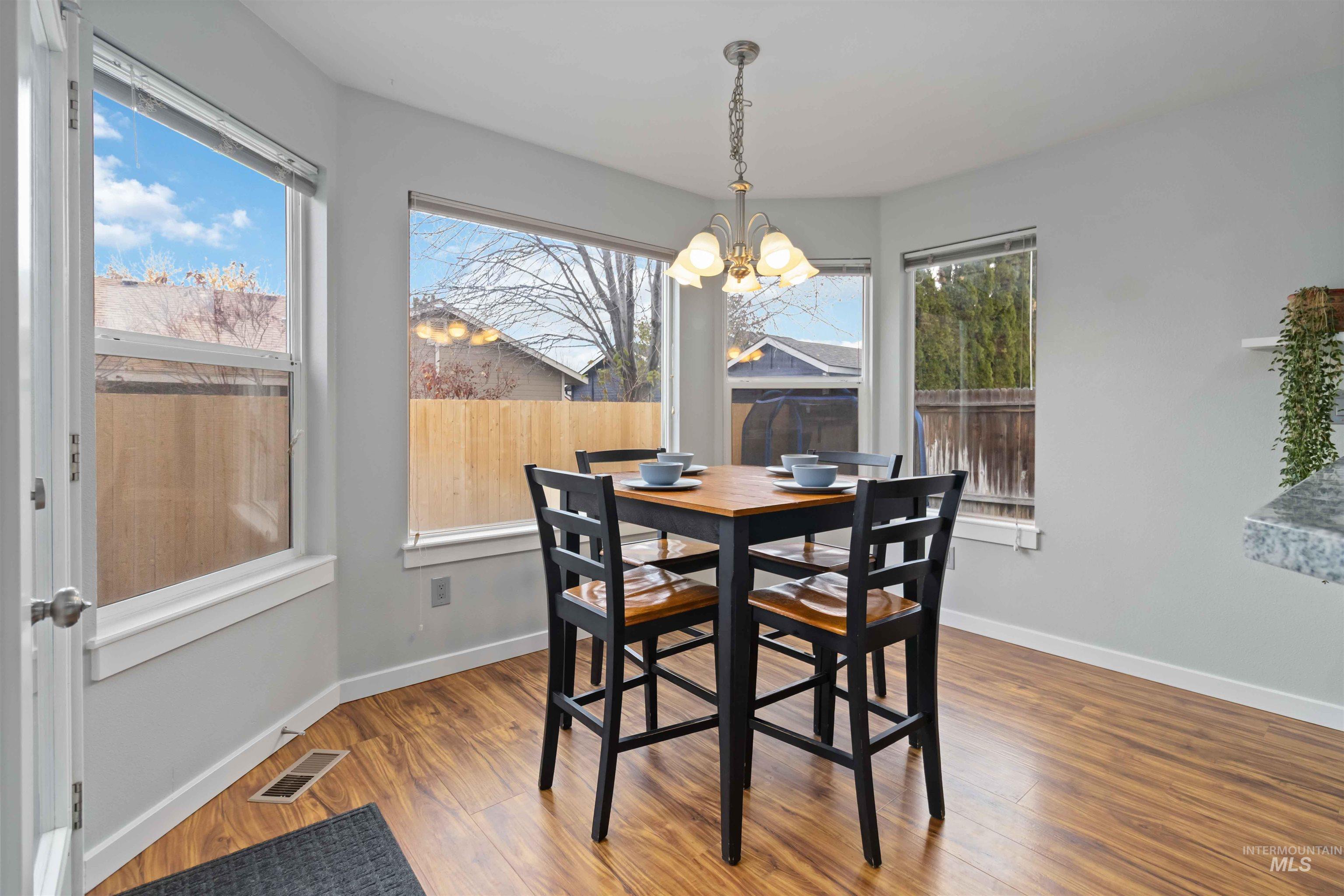 Dining room featuring wood finished floors and a chandelier