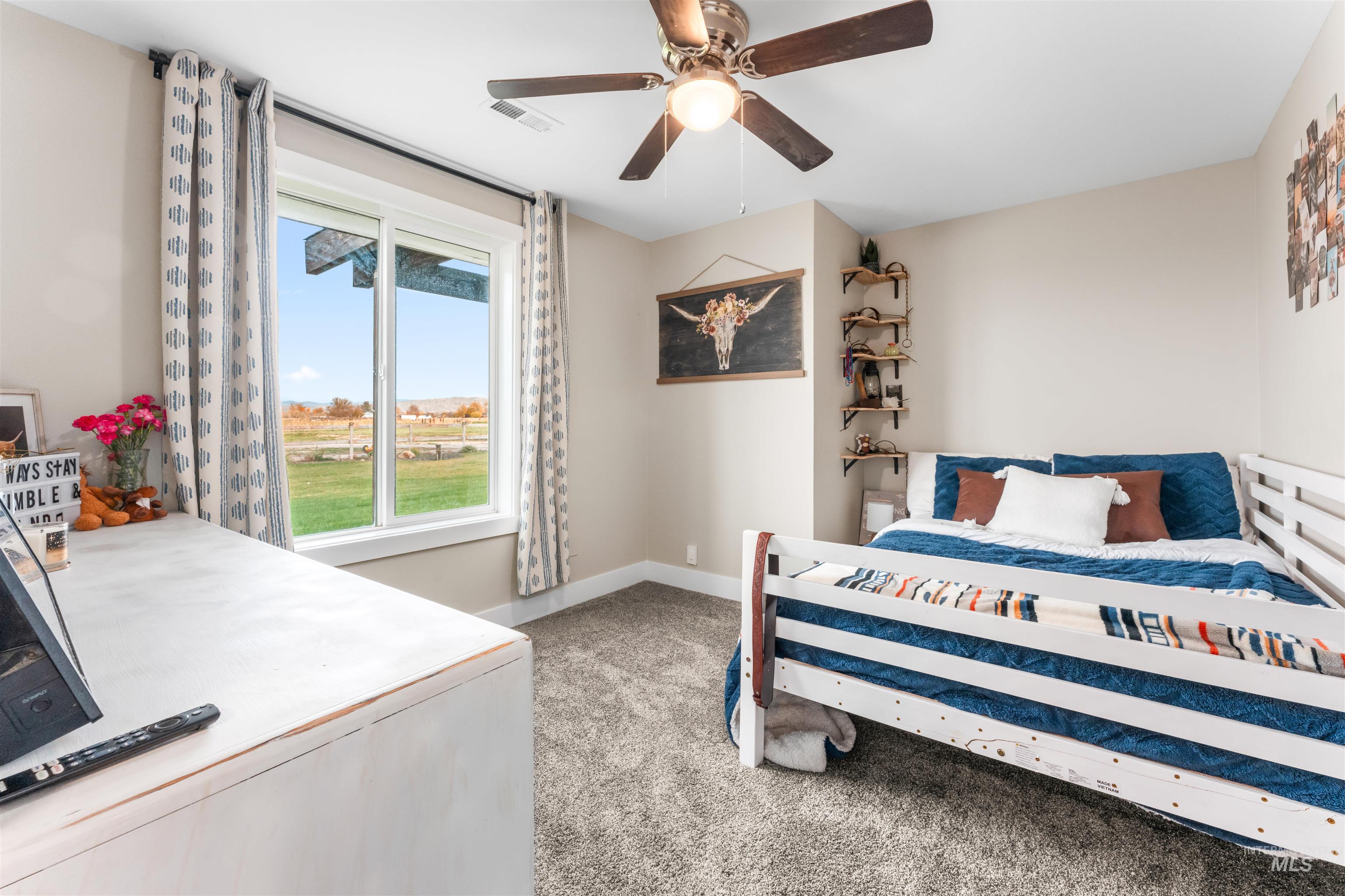 Bedroom featuring light carpet and ceiling fan