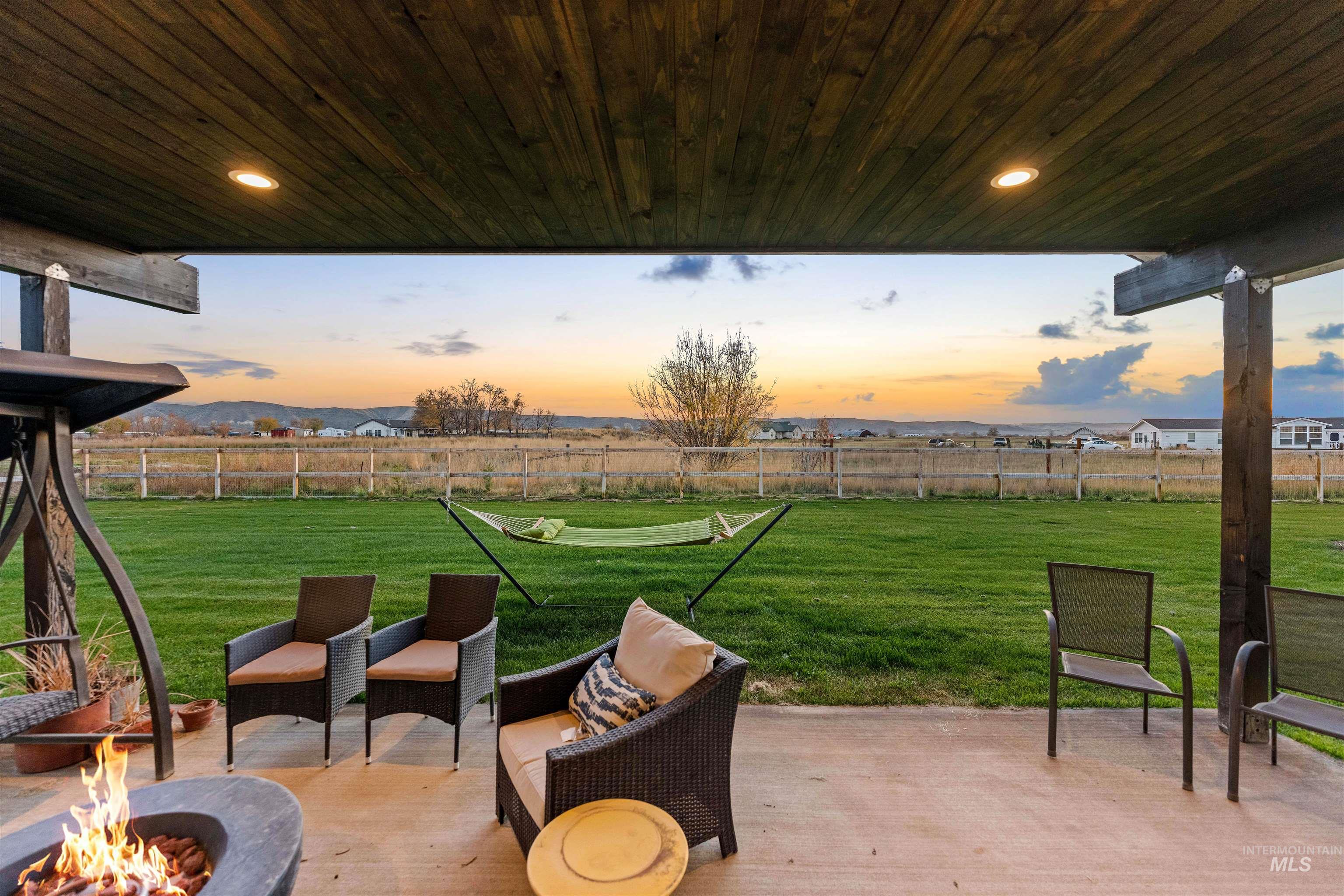 Fenced backyard with a patio and an outdoor fire pit
