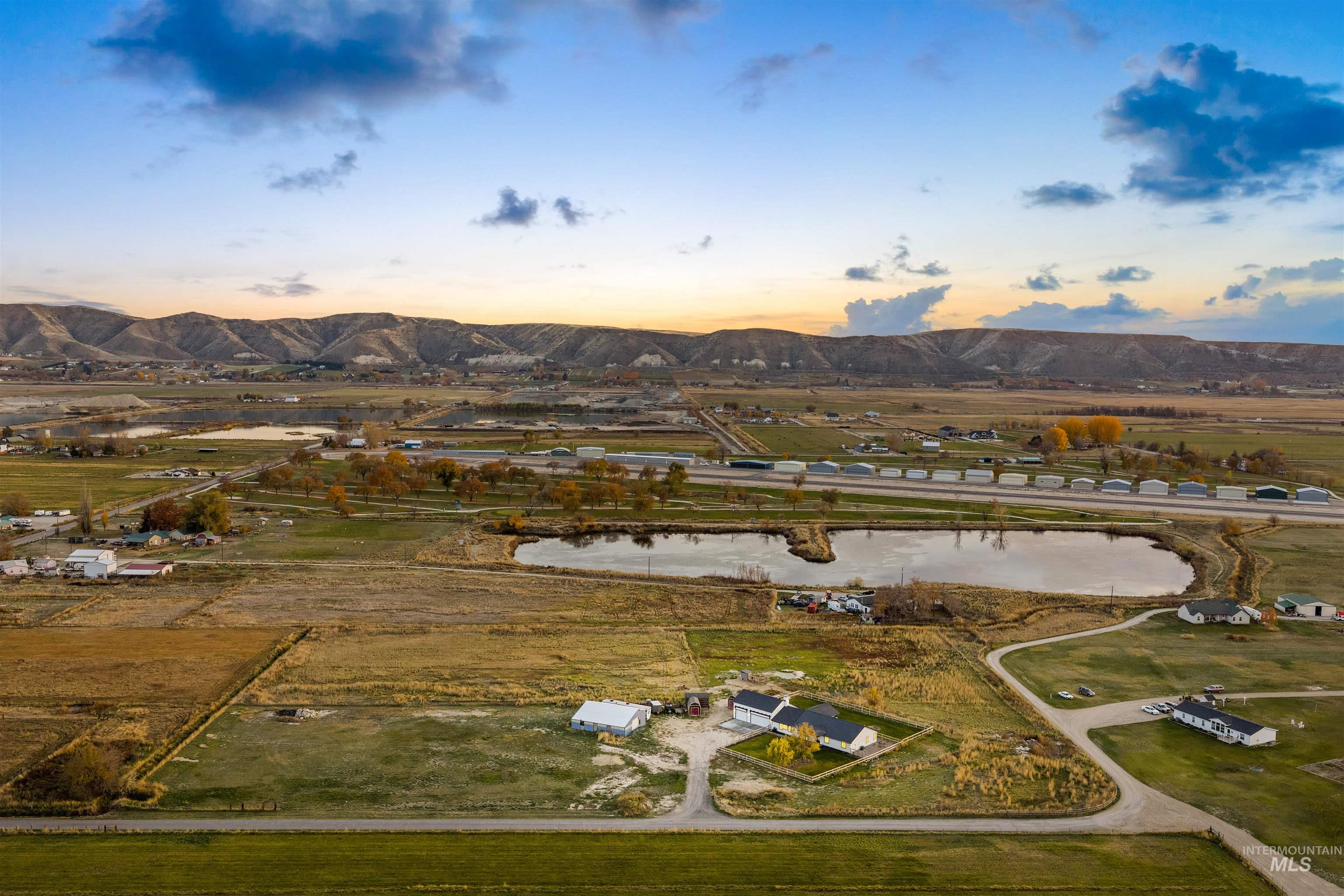 Aerial overview of property's location with a water and mountain view and rural landscape