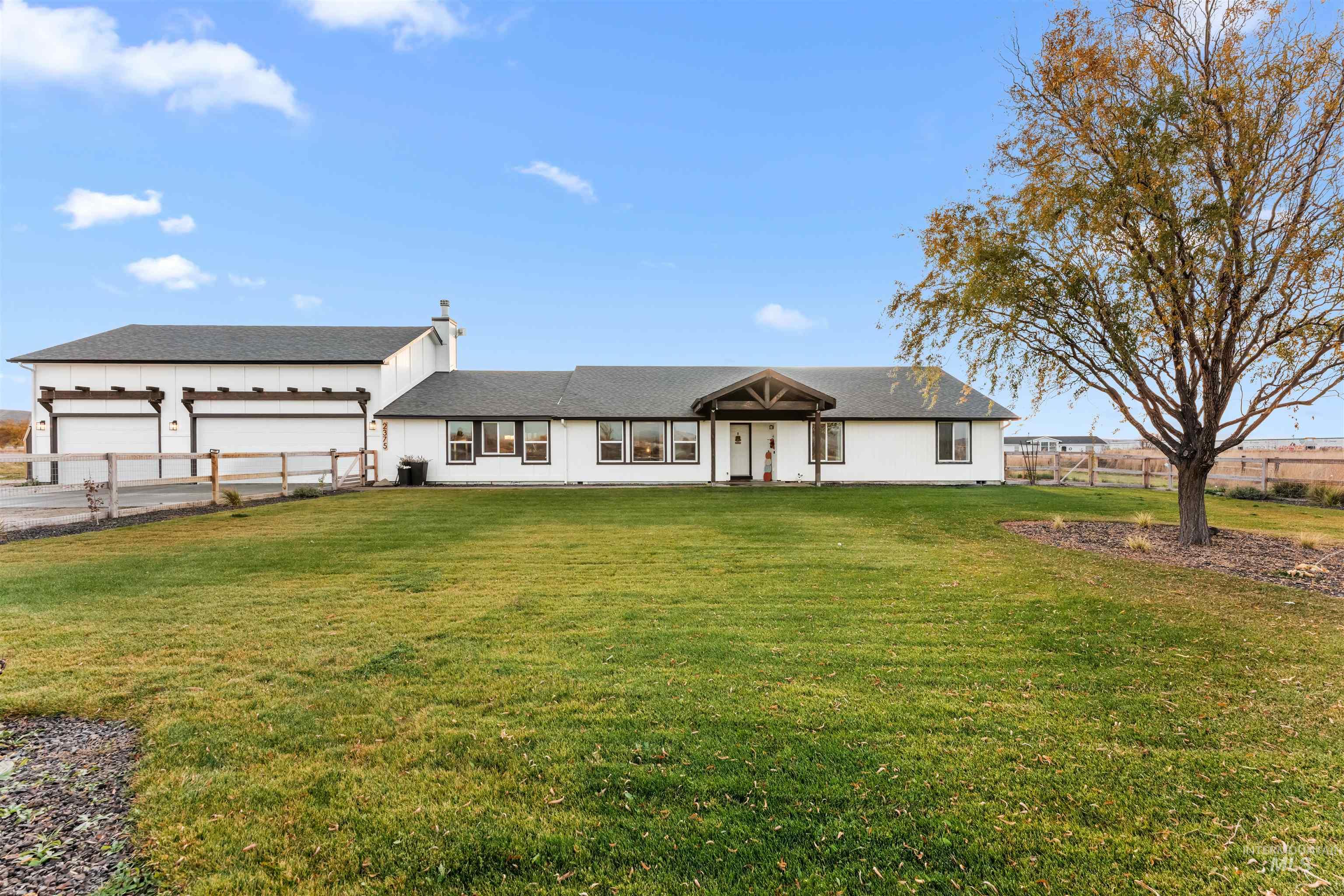 View of front of home featuring a shingled roof and a chimney