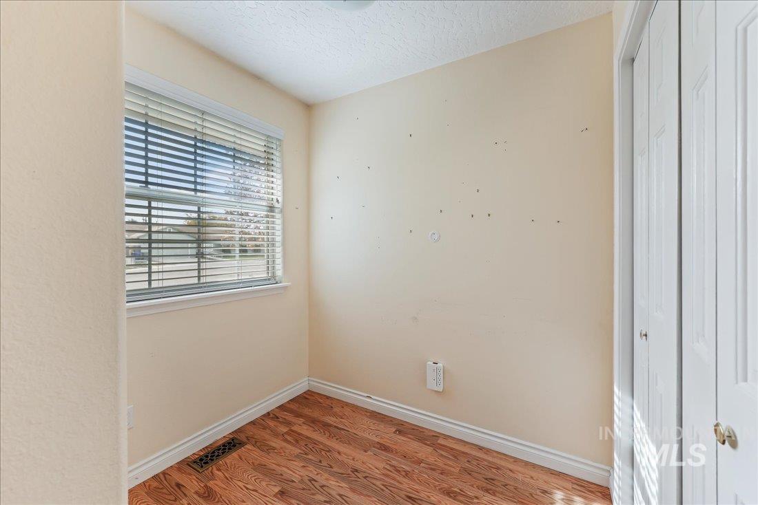 Spare room featuring light wood-style floors and a textured ceiling