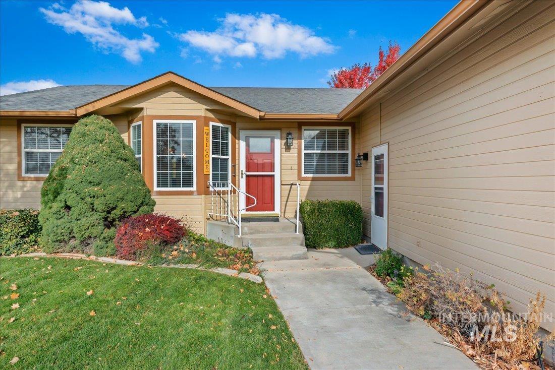 Doorway to property featuring a yard