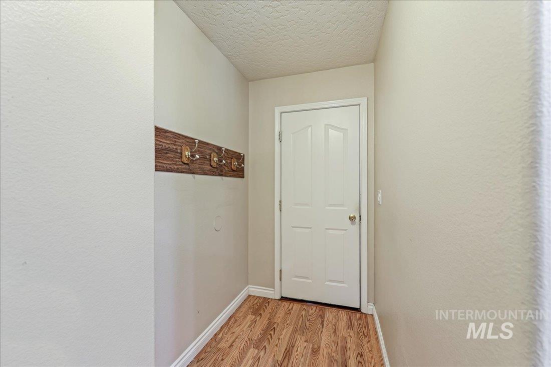Entryway with wood finished floors and a textured ceiling