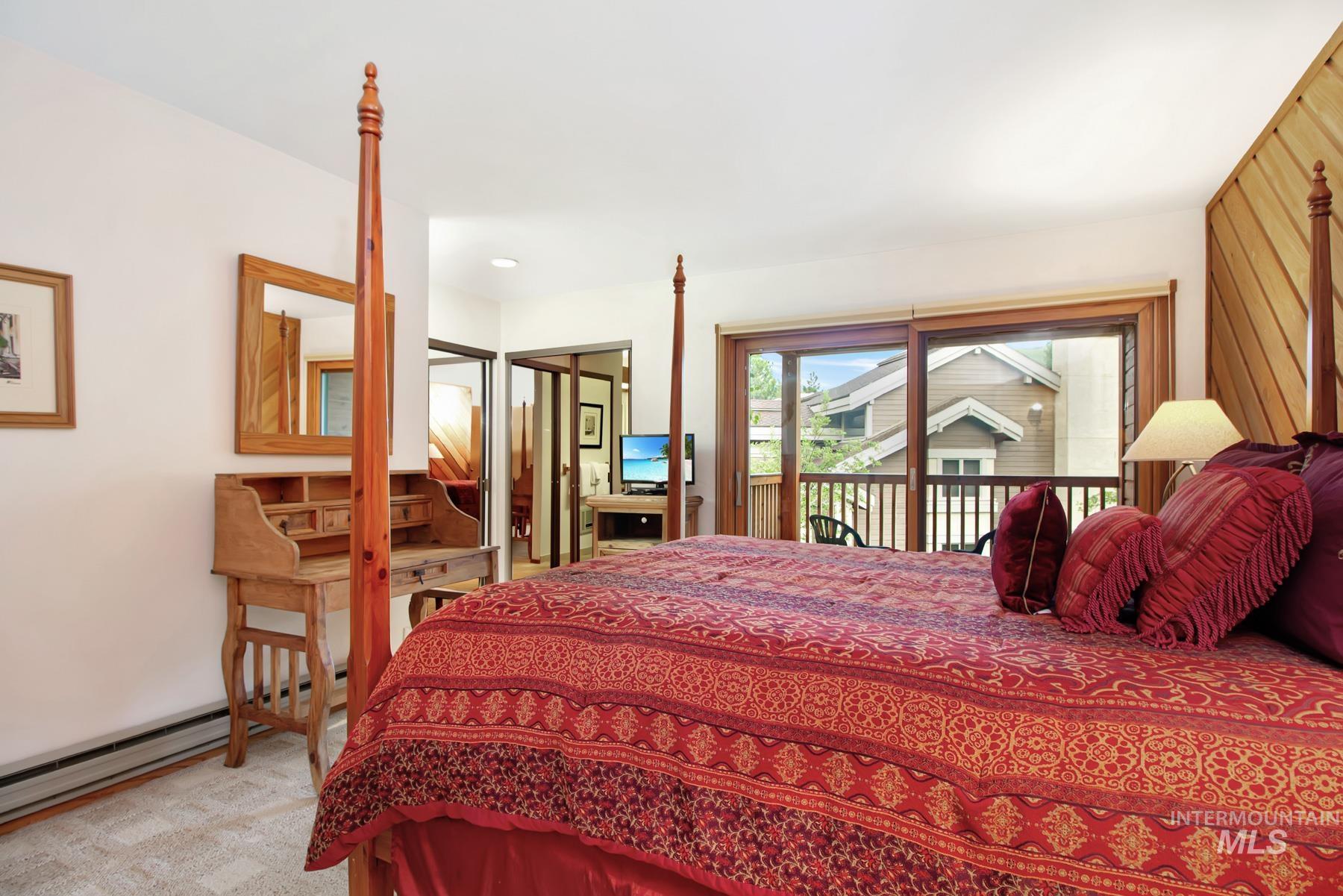 Bedroom featuring access to exterior and carpet floors