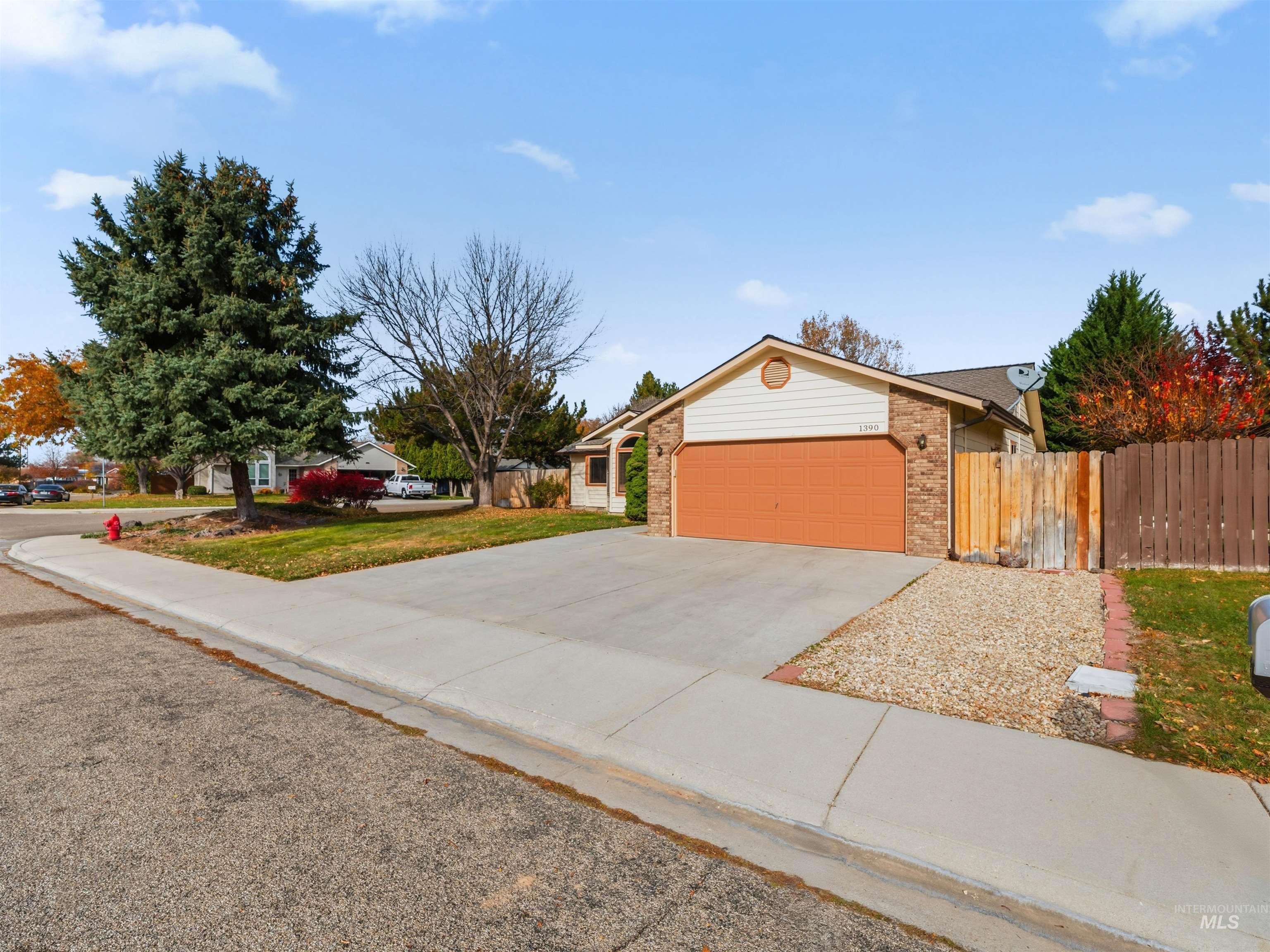 View of front of home with concrete driveway, brick siding, and a garage