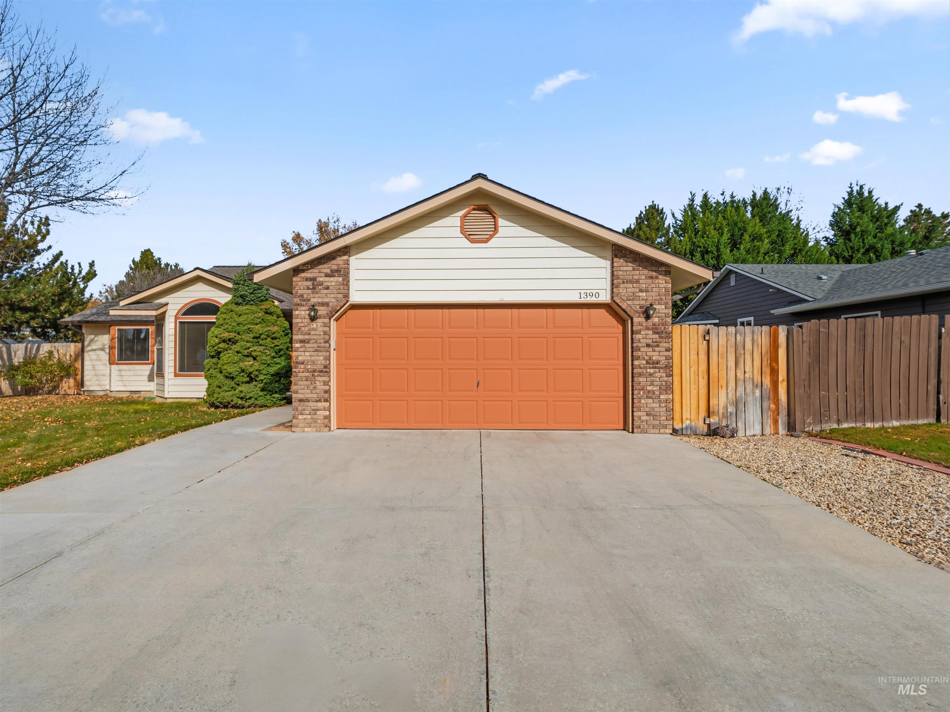 Ranch-style house featuring driveway and brick siding