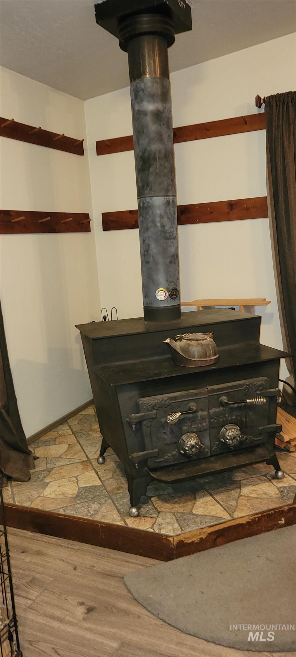 Detailed view of wood finished floors and a wood stove