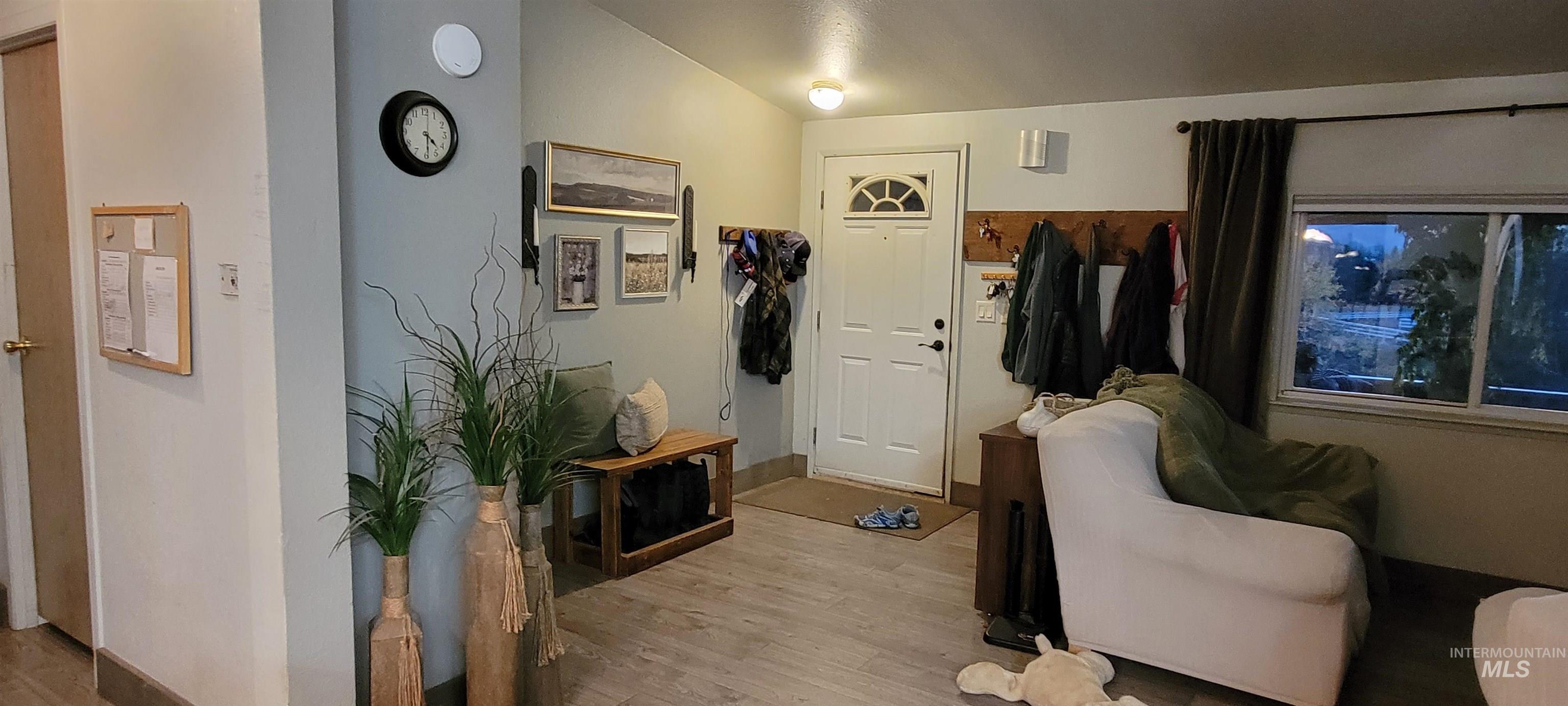Entrance foyer featuring wood finished floors and lofted ceiling