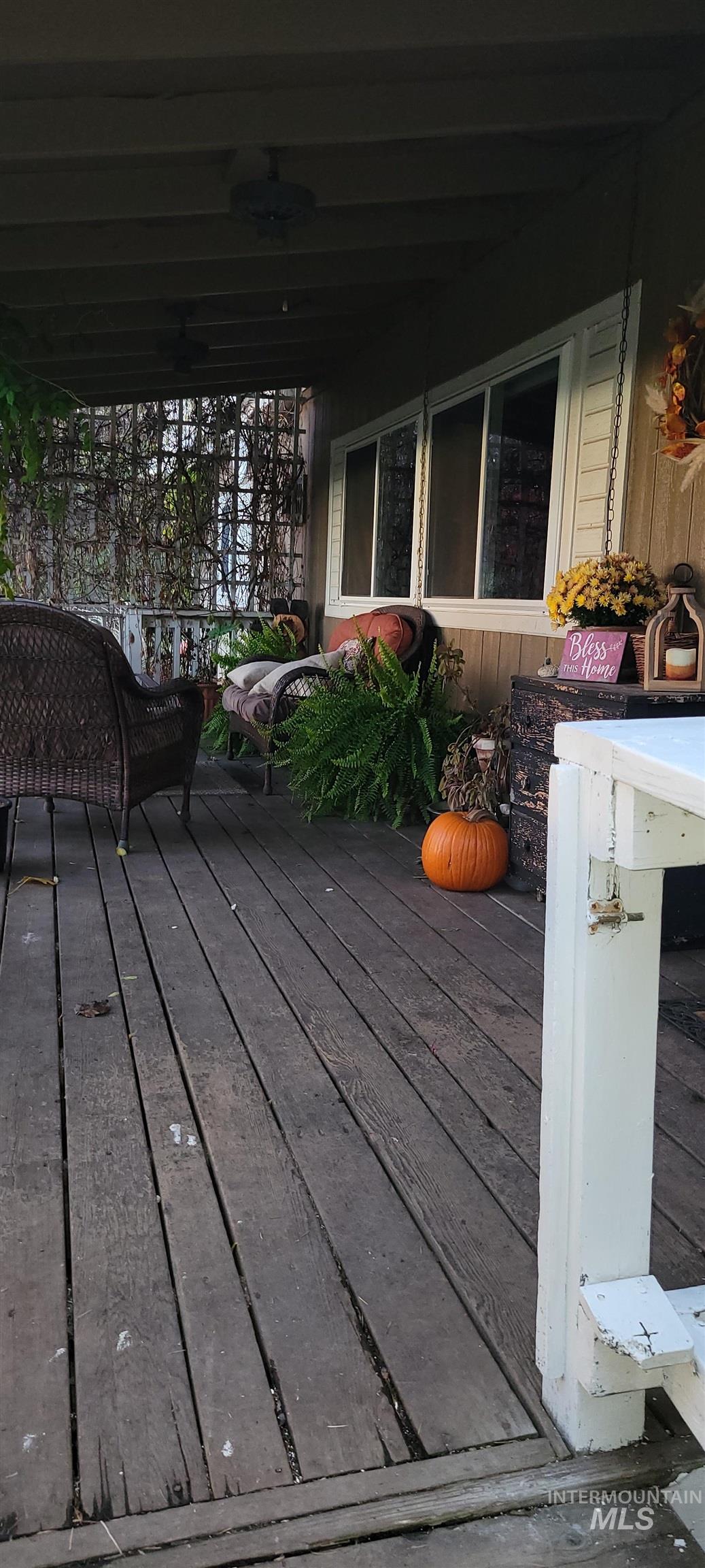 Wooden deck featuring ceiling fan