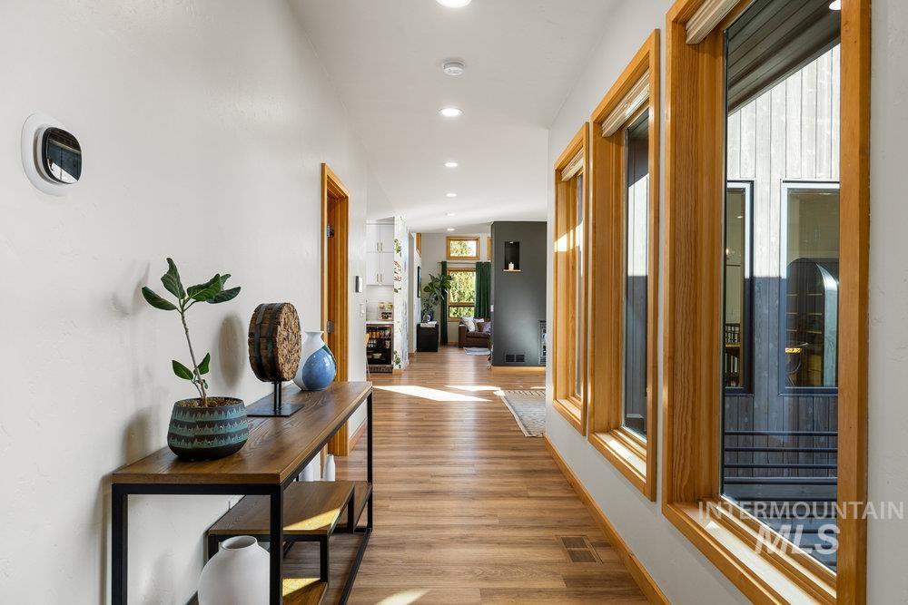 Corridor featuring light wood-style flooring and recessed lighting