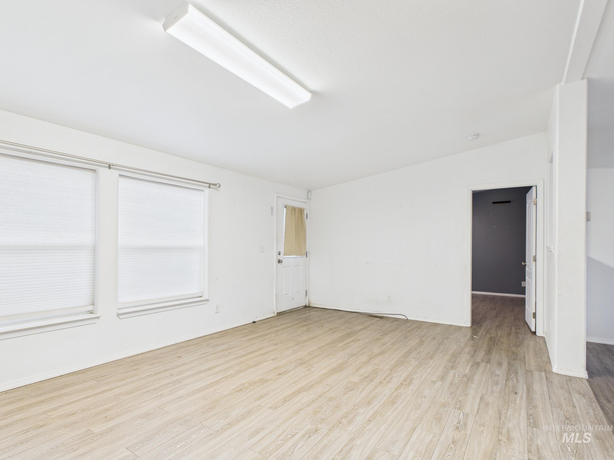 Spare room with light wood-type flooring and baseboards
