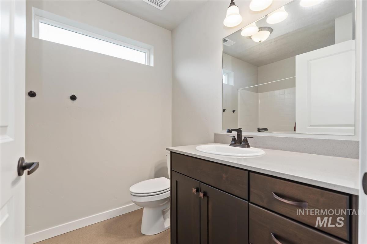 Bathroom featuring vanity and a shower