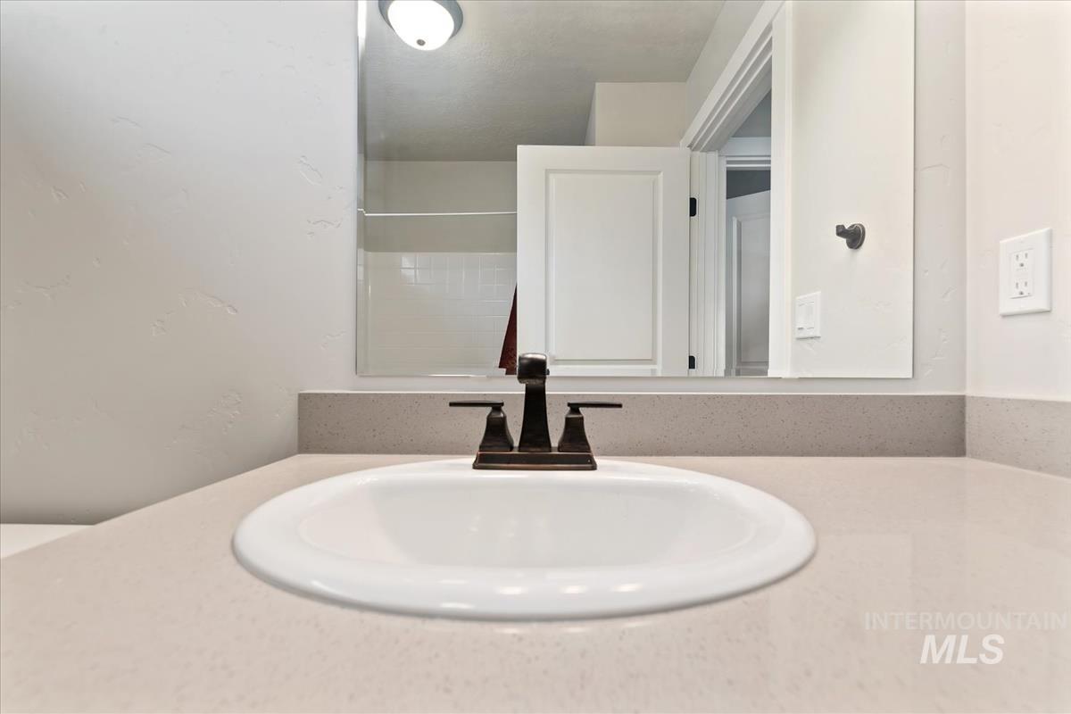 Bathroom view of vanity and a shower