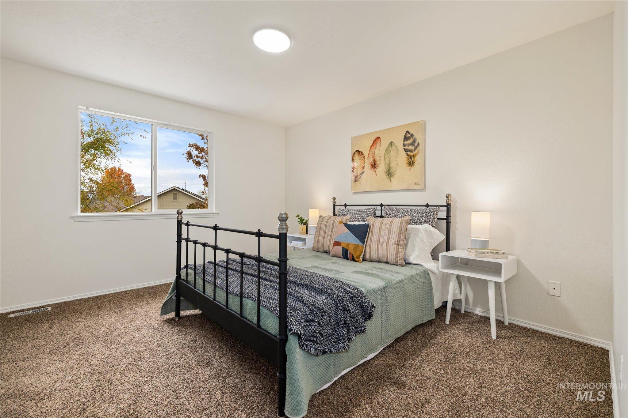 Bedroom featuring carpet flooring and baseboards