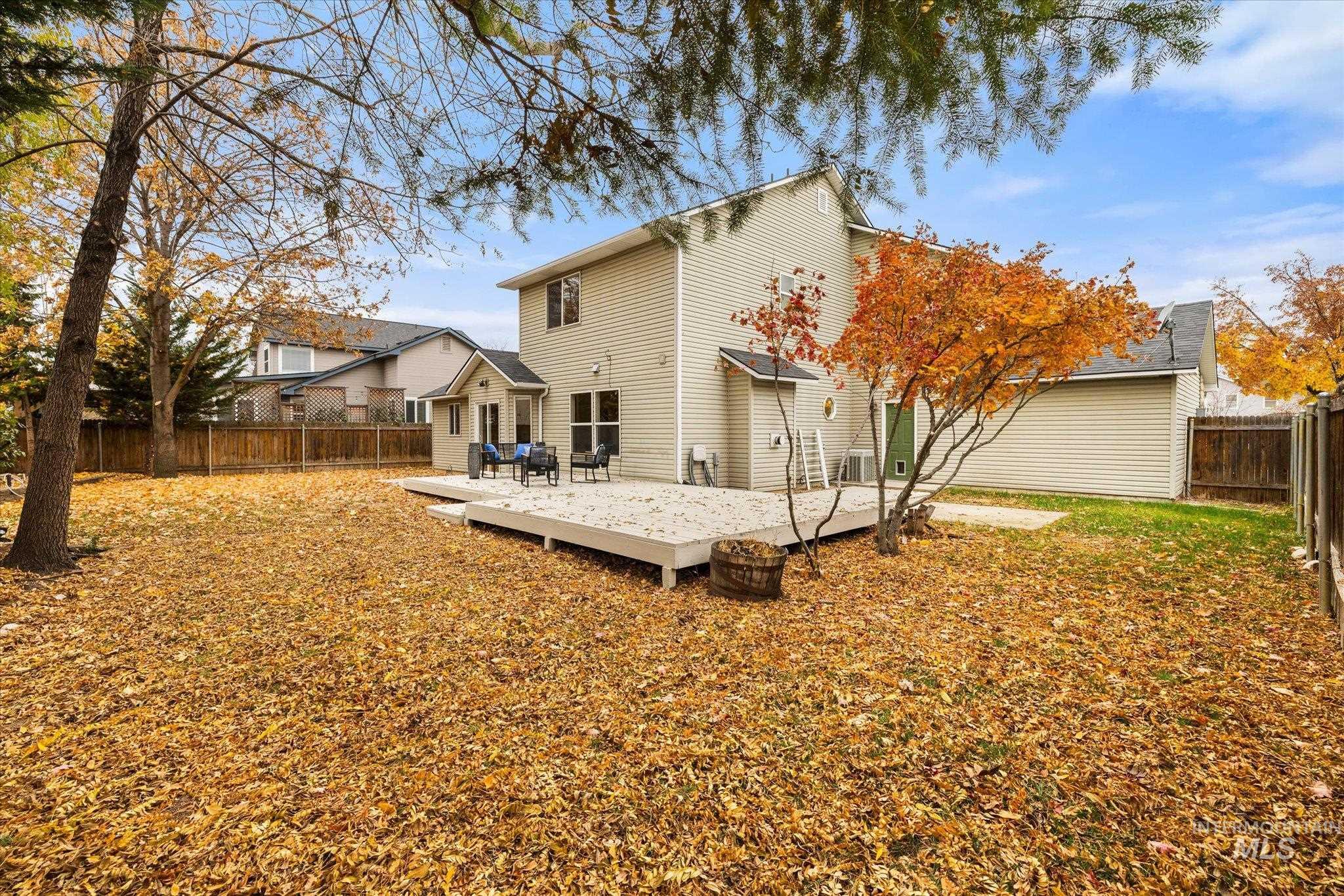 Back of property with a deck and a fenced backyard