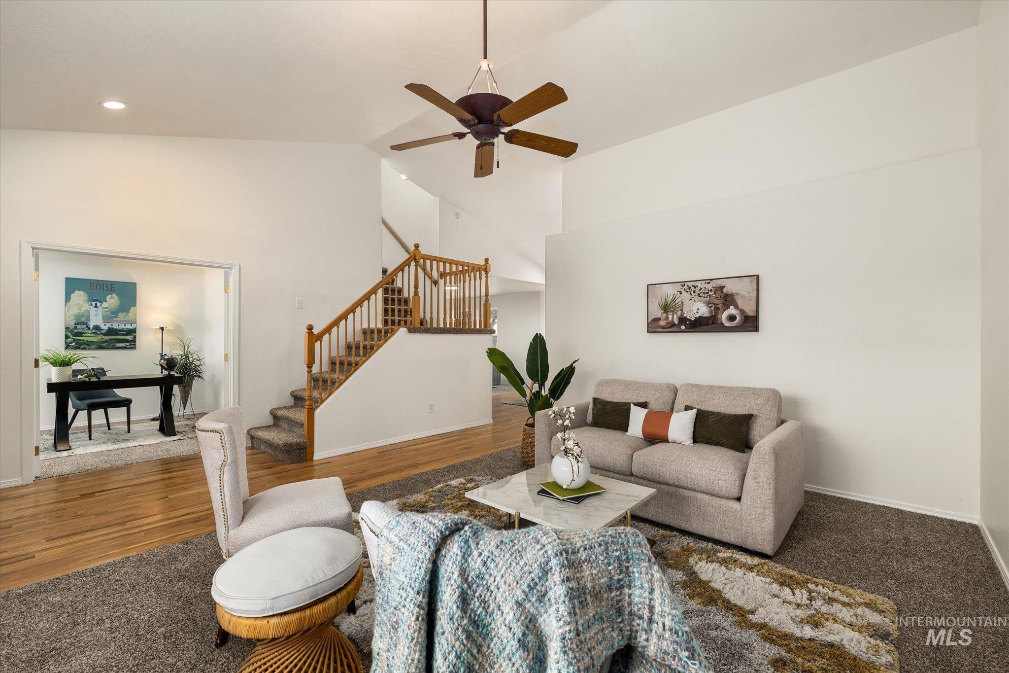 Living area with stairs, high vaulted ceiling, ceiling fan, wood finished floors, and recessed lighting