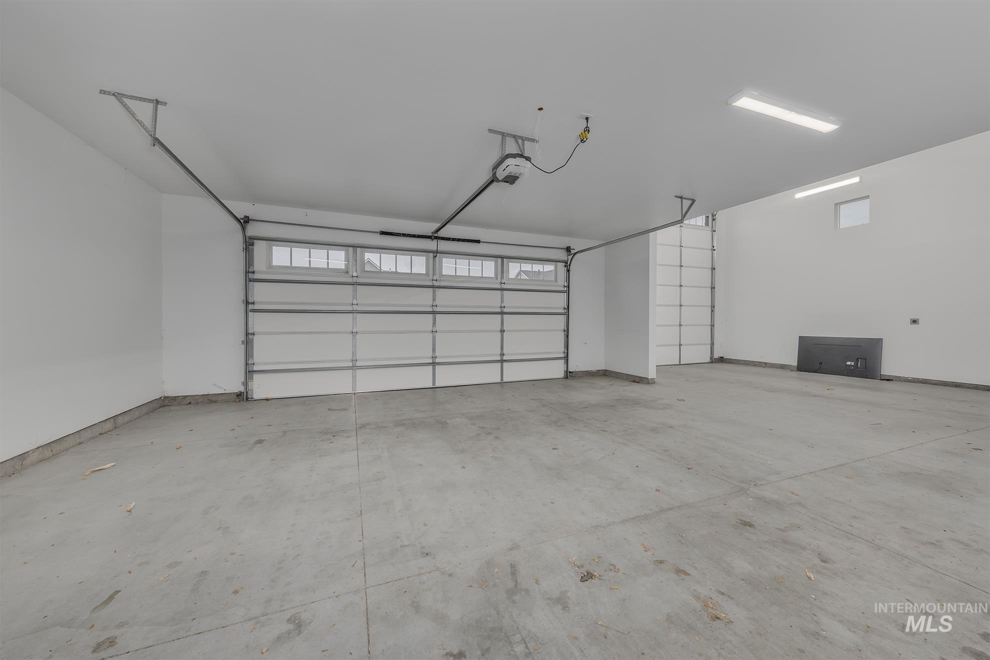 Garage featuring a garage door opener