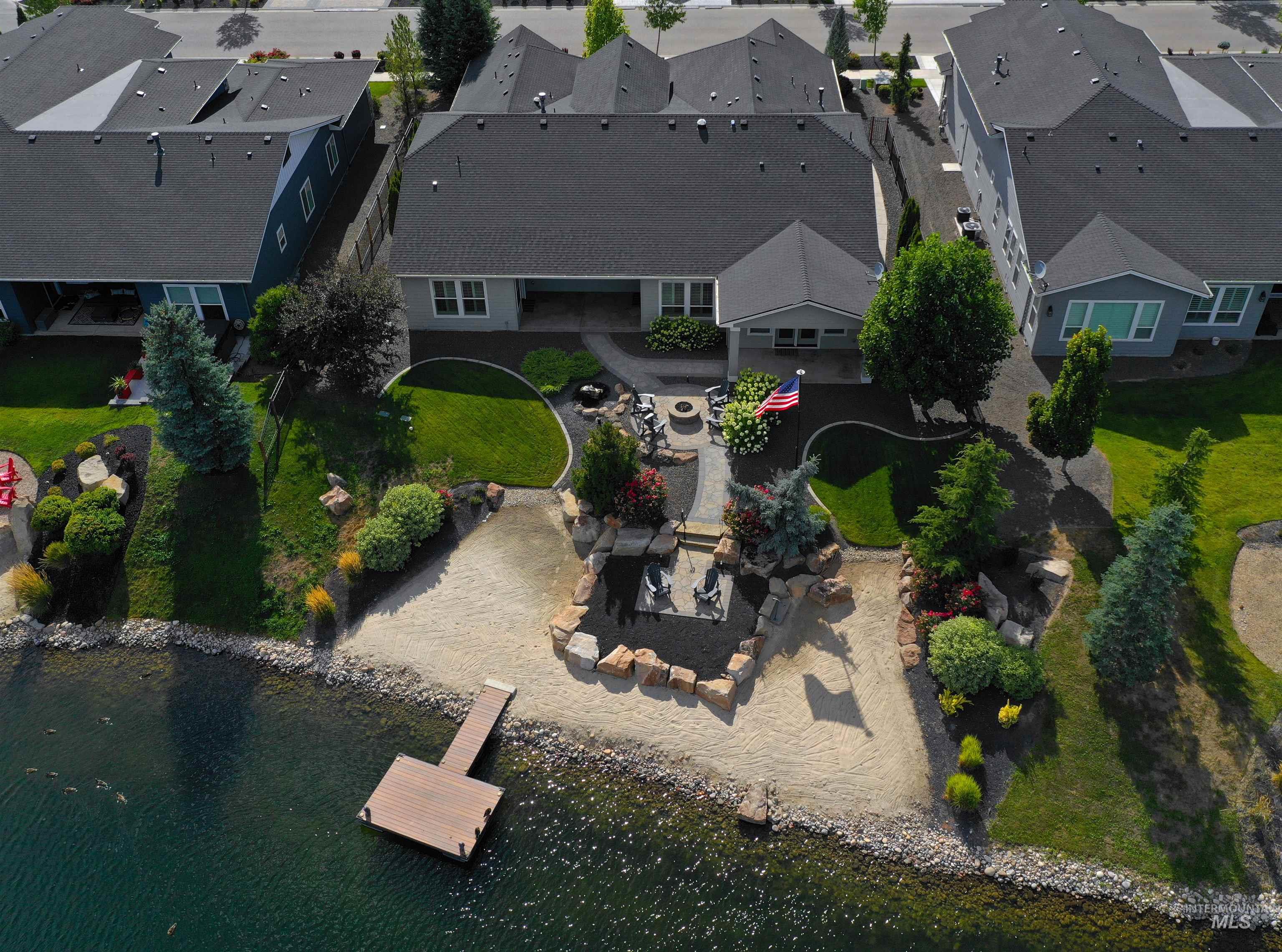 Aerial view of property's location featuring nearby suburban area and a large body of water