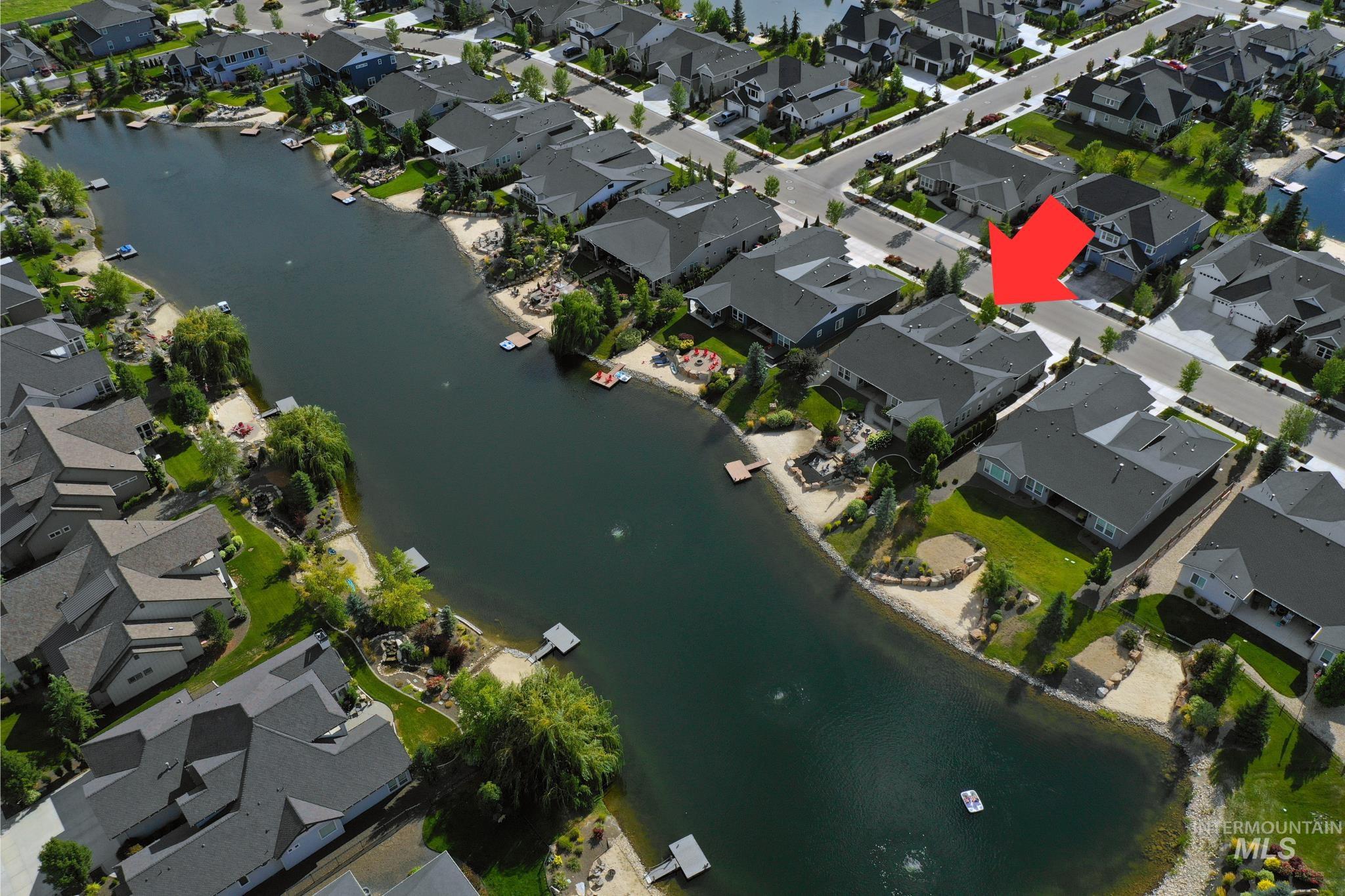 Aerial overview of property's location with a large body of water and nearby suburban area