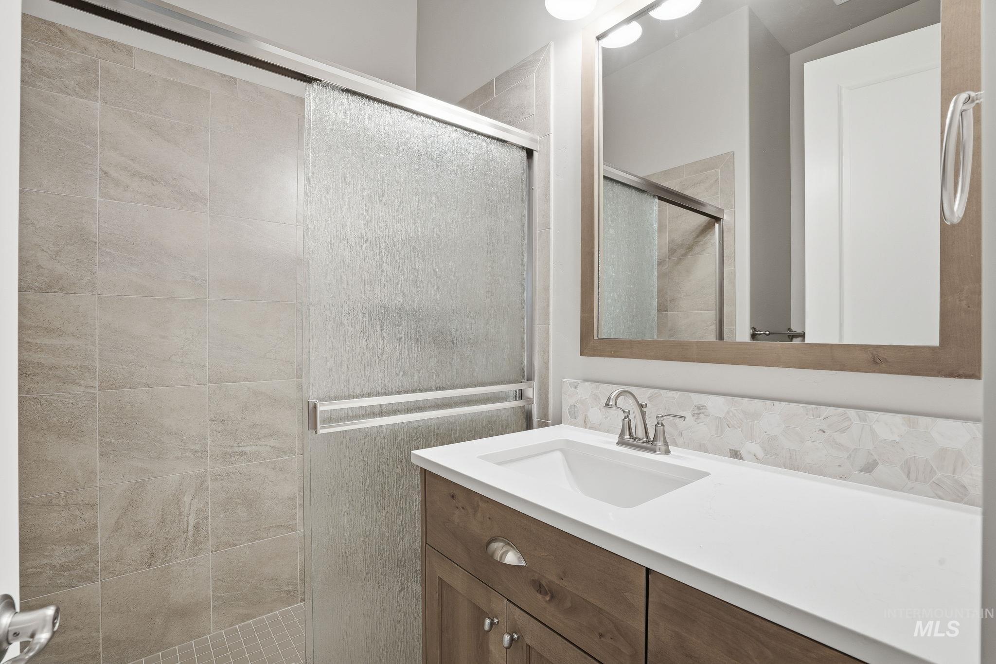 Bathroom with a shower stall and vanity